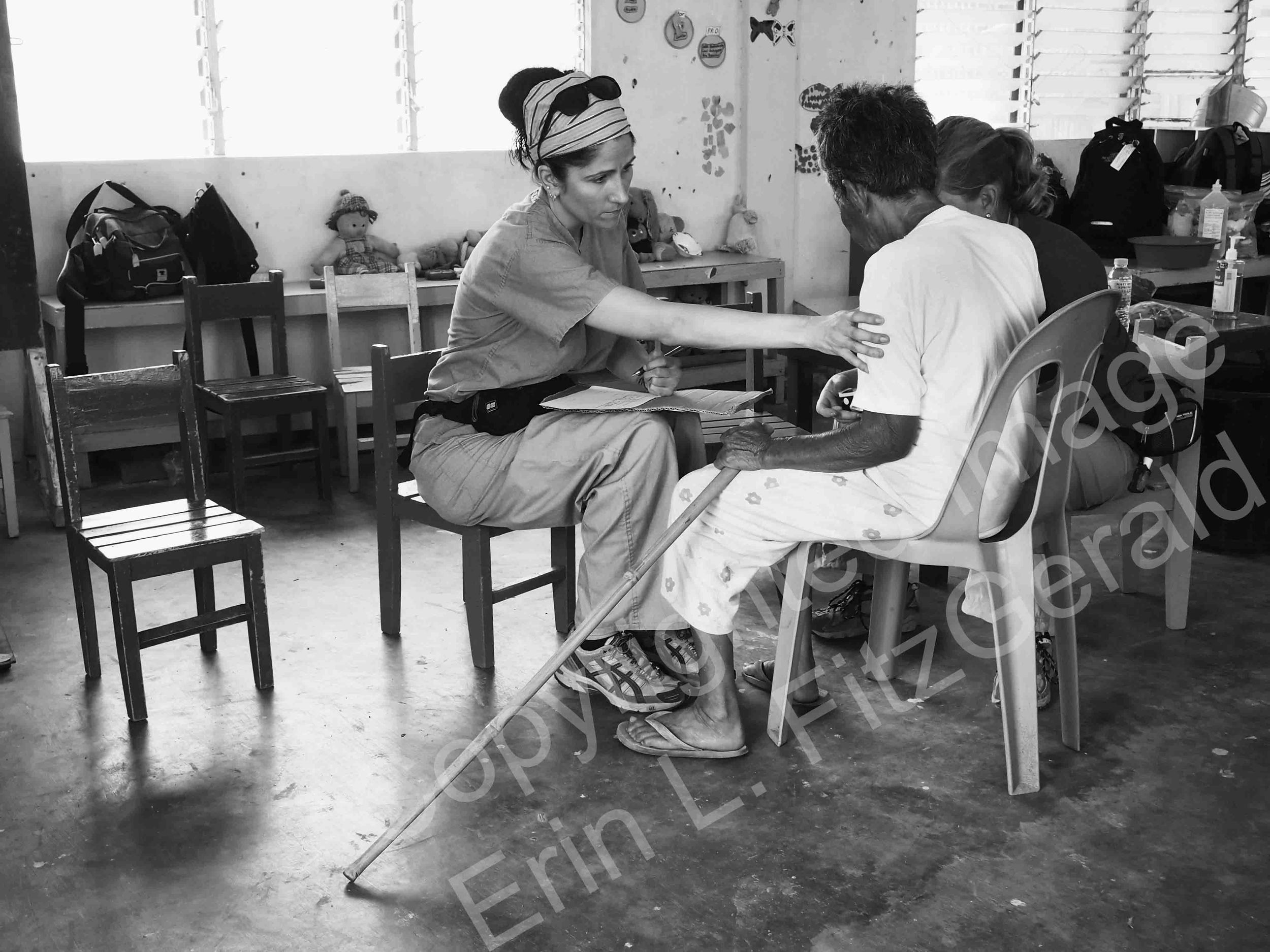  A nurse from California cares for an elderly patient at a schoolhouse converted to a medical clinic in Estancia in the Philippines. Coastal communities were devastated by Typhoon Haiyan.    