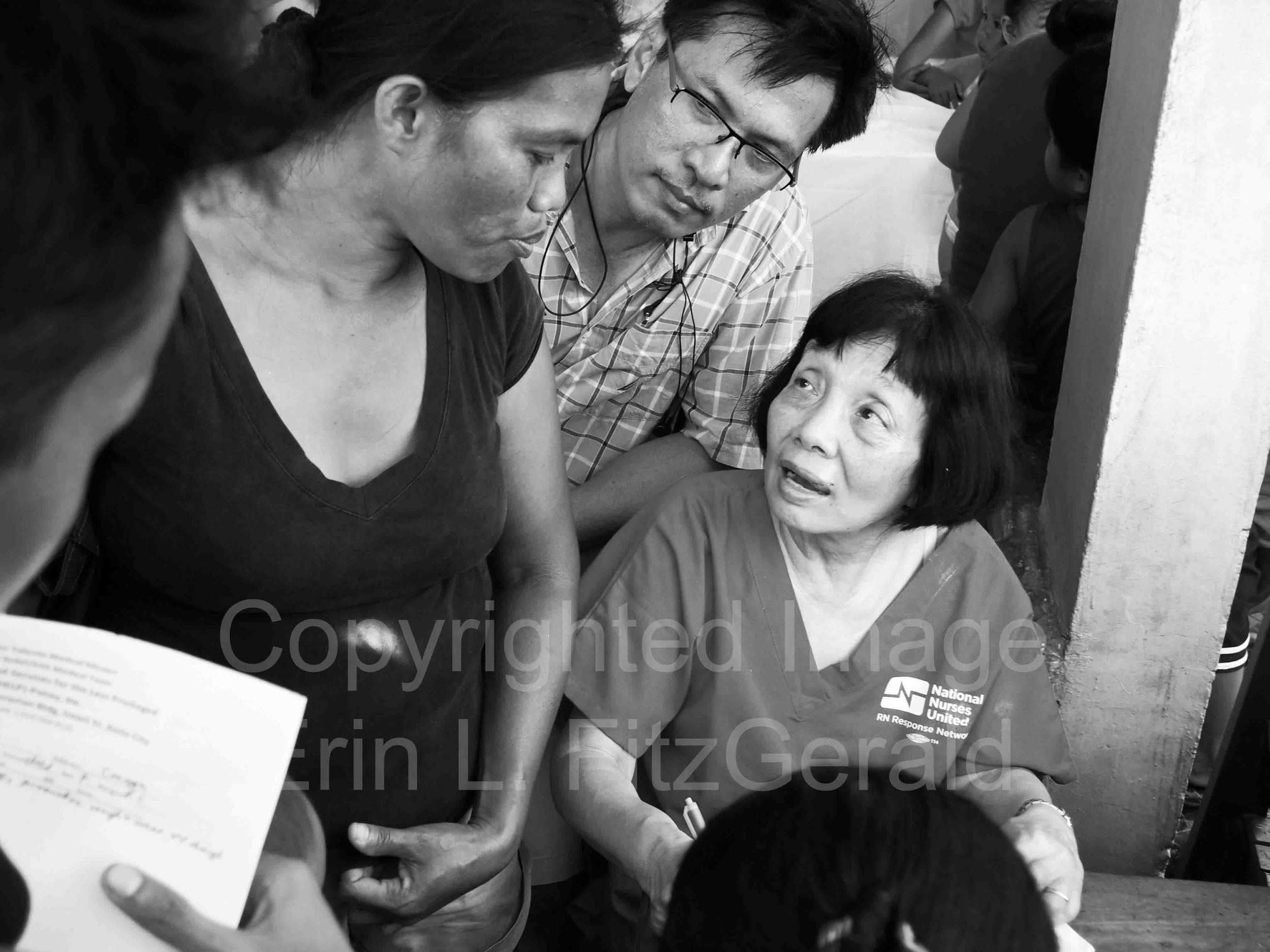   RN Stella Auto counsels a woman on her pregnancy at a makeshift clinic set up to serve survivors of Typhoon Haiyan.  