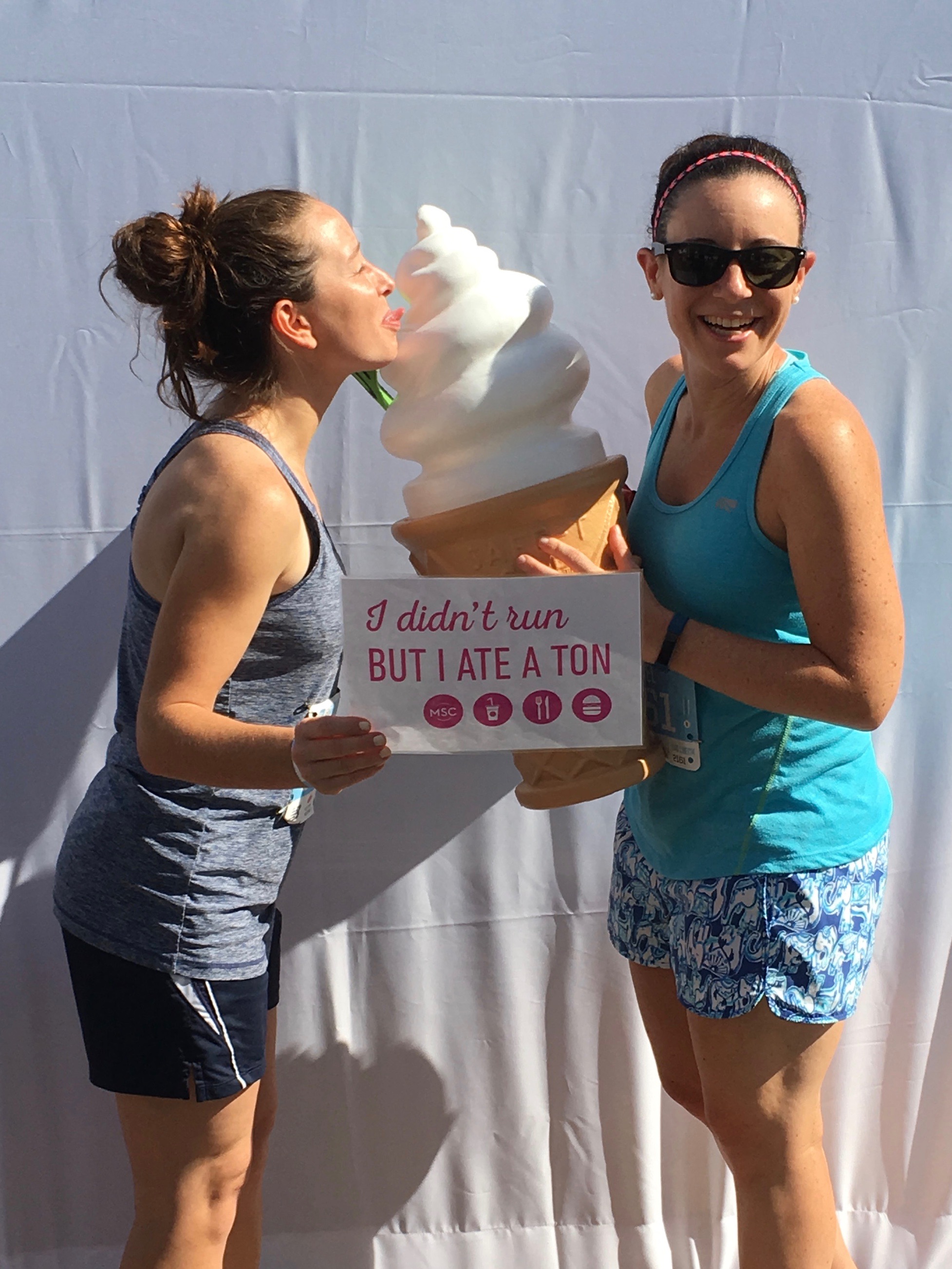 Runners posing with photo booth signs at MSC’s post-race festival