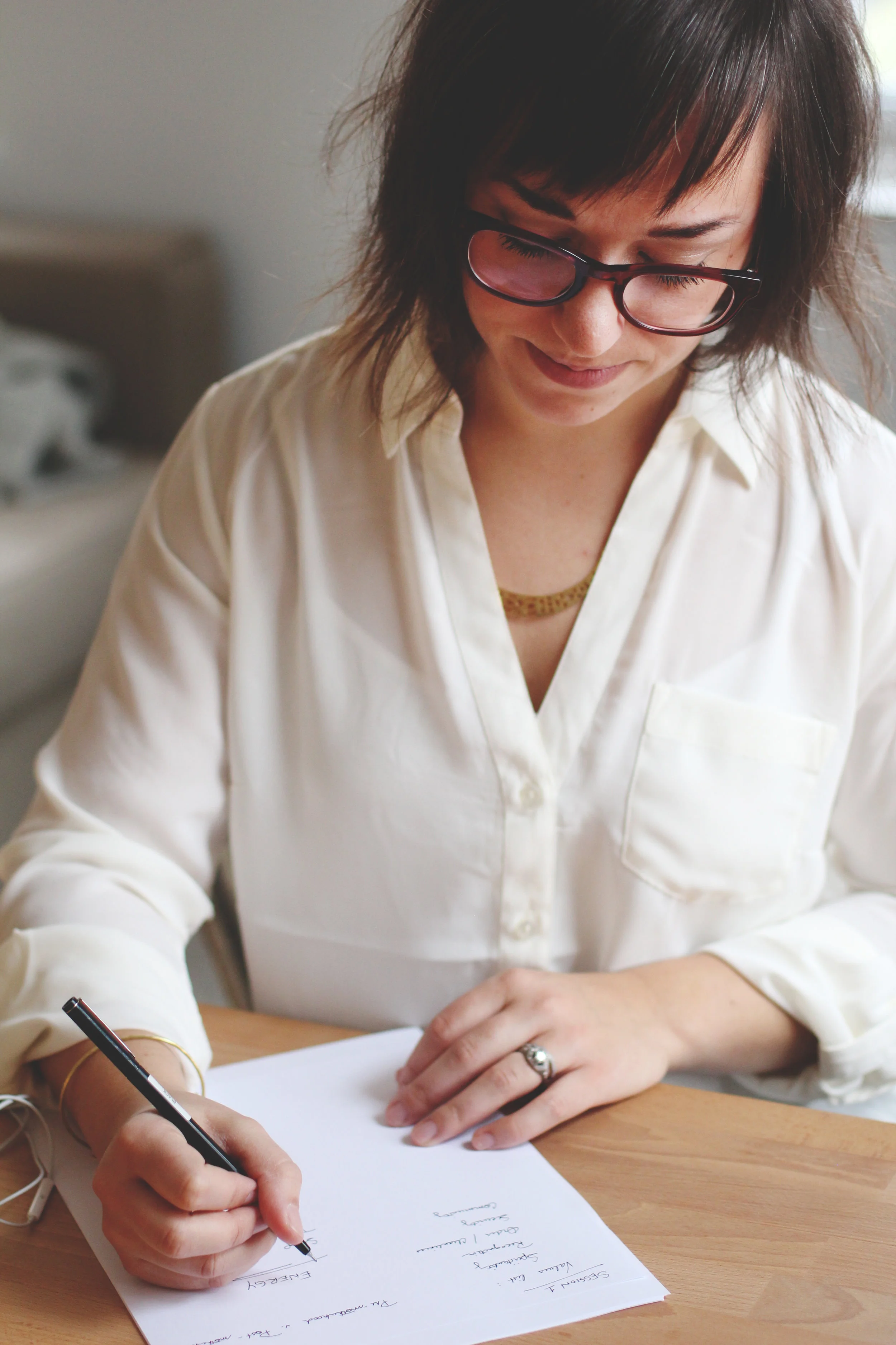 lady looking down writing on a piece of paper