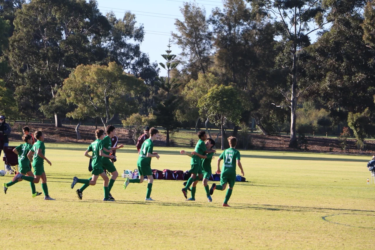 The 14 Boys celebrate Meng's goal against Dianella SC