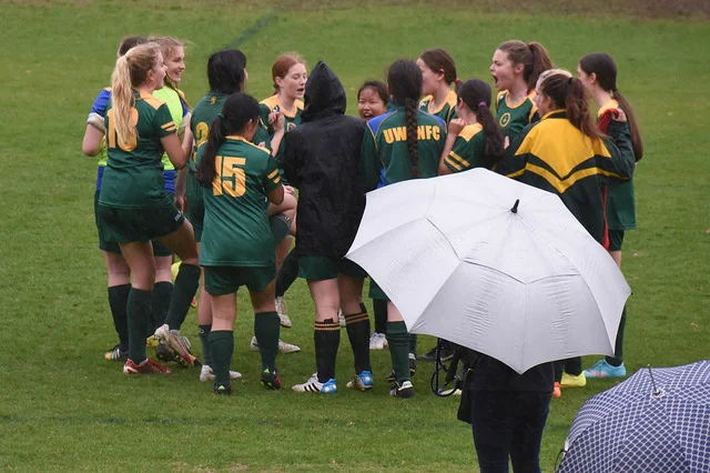 The U17 Girls huddle up at half time - Photo Courtesy of Bill Hallager