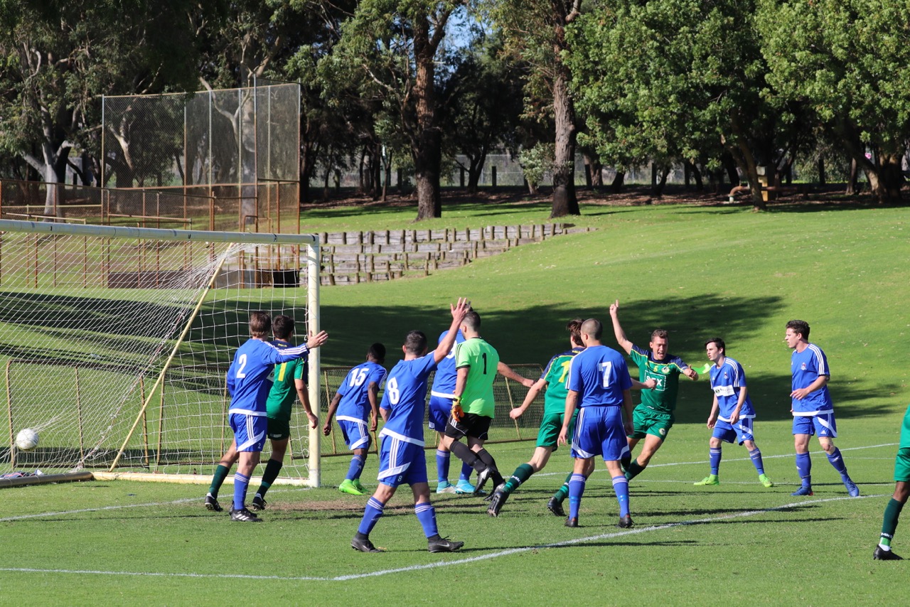 SKIPPER JOSH MAROCCHI CELEBRATES AFTER HEADING UWA TO A 2-0 LEAD - CREDIT: GABRIELE