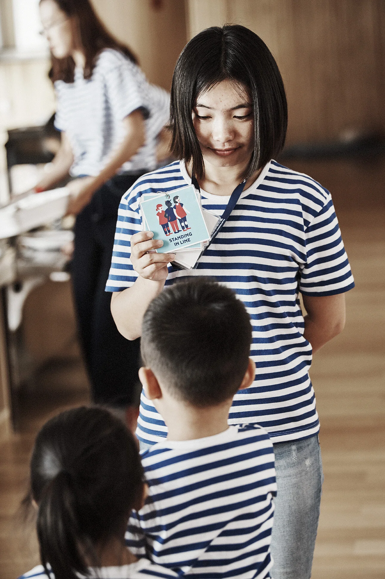 Teacher with HEI Pictogram in hand   Source: HEI Schools
