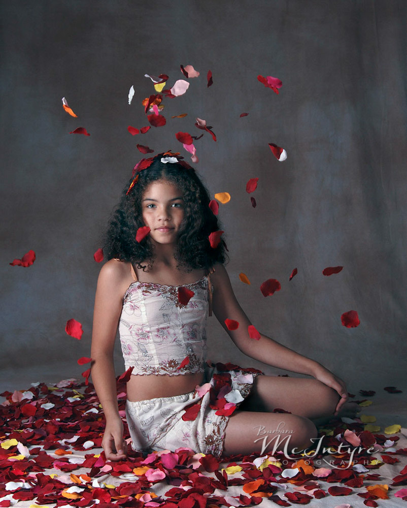August 2005, Age 9 (almost 10) Maya was loving her first inklings of womanhood. She threw the silk rose petals into the air herself, then quickly brought her arm down to hide the movement and heighten the mystery.