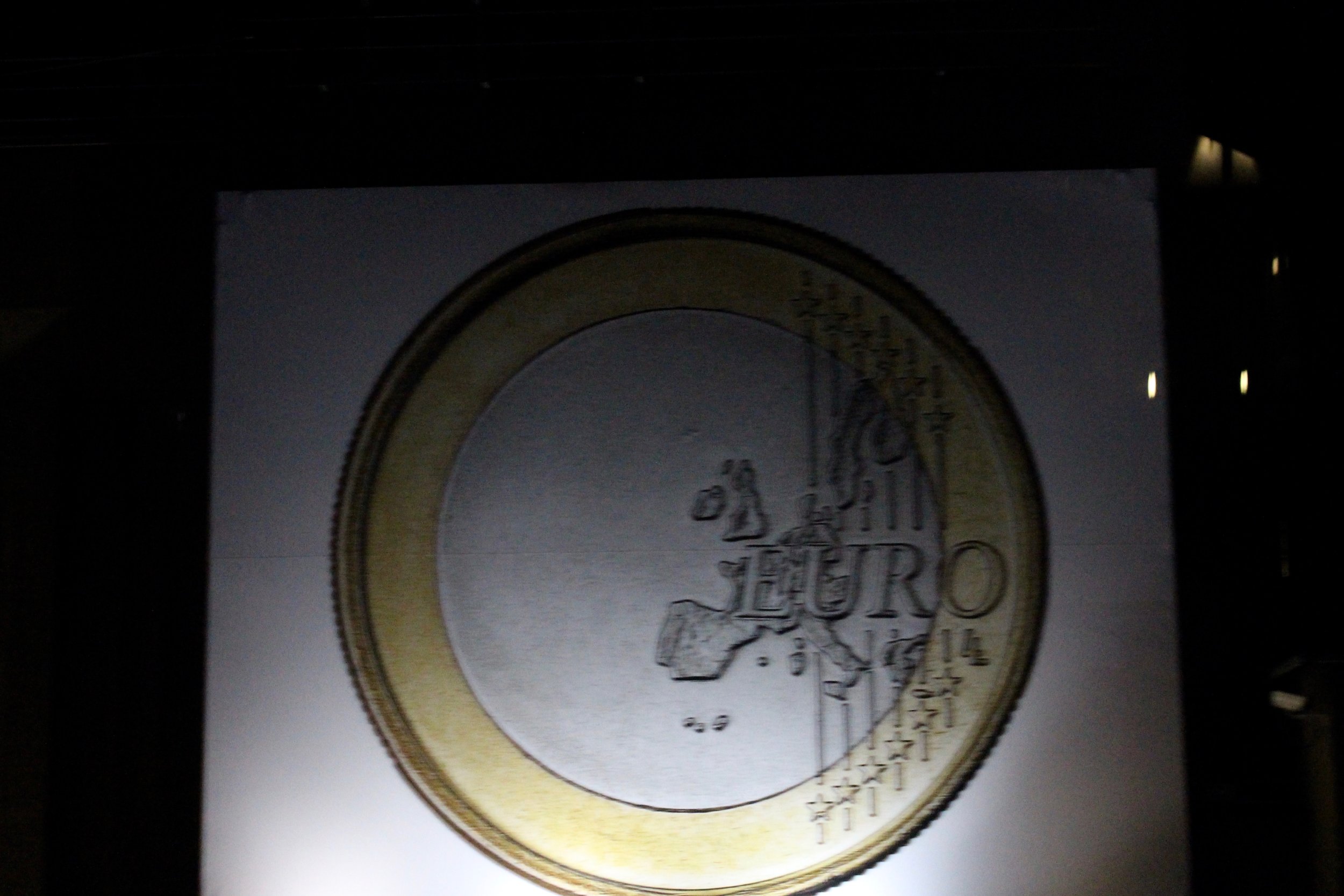 An euro coin on the wall of a giant building we`ve passed...