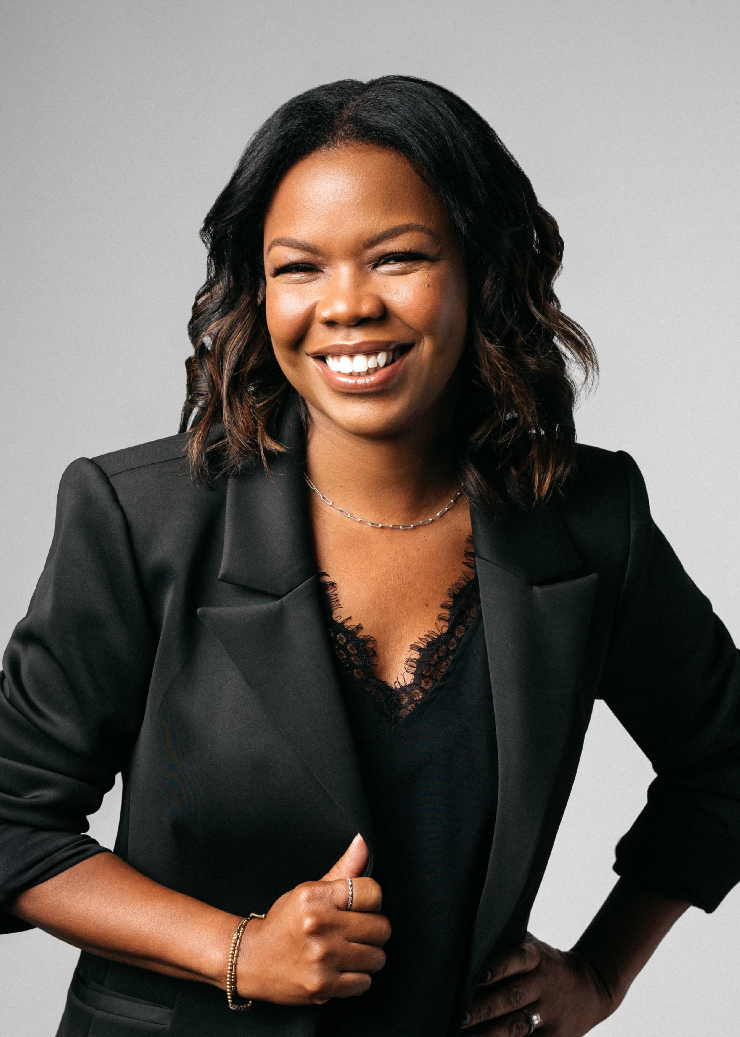 Female entrepreneur laughs naturally during studio branding session.