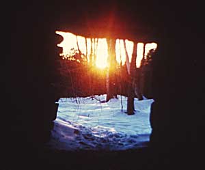 Winter Solstice Sun rising through a notch in the terrain, as seen from the central chamber of Calender 11 Photo by Byron Cox