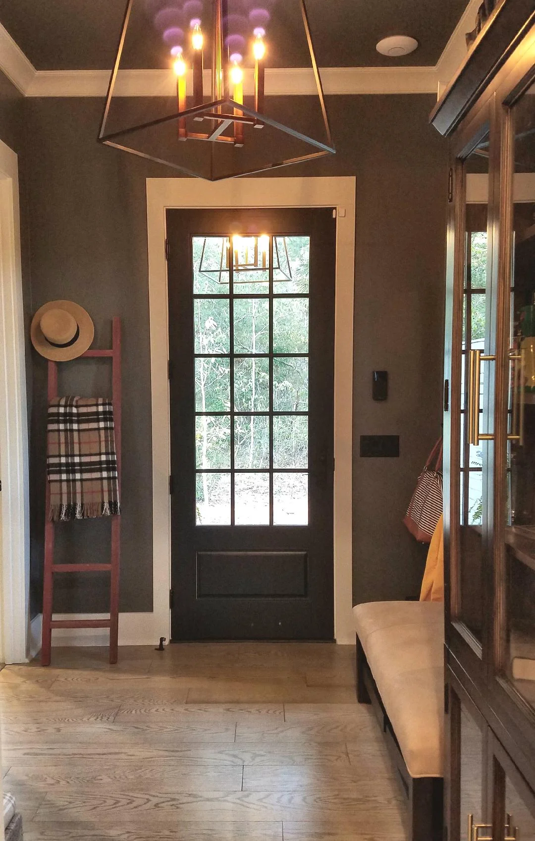 To the right of the door (above the light switch plate) in this gorgeous mudroom is the SimpliSafe keypad.