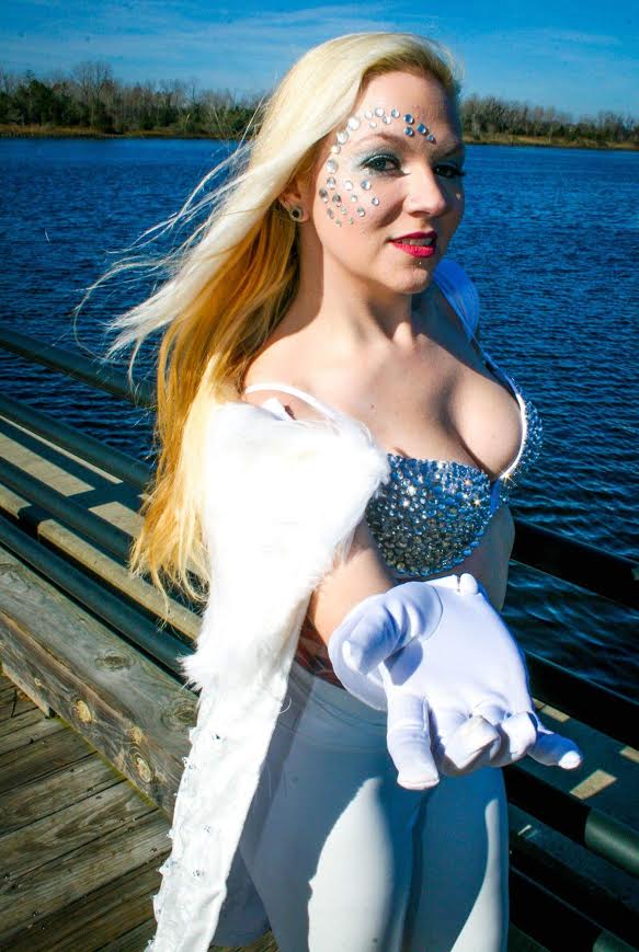 Emma Frost- Xmen Cape and bra done by me, and if I EVER say I will remake this lock me up because I lost it. The bra and pants was purchased, but I added individual rhinestones to the bra one by one. The cape (which you can't tell from this picture) is two layers. The bottom layer has LED lights sewn onto it. The top layer was added after the LED's were sewn in and I pulled and white glued them in place to the top velvet layer. This was SUPER time consuming and tedious. Then for the finishing touches I added the white fur. This cape SCREAMS Emma since the LED's glitter and glisten. I will get photos of this in the snow if it's the last thing I do! Emma was chosen because simply I love glitter and the fact that she uses her sexuality as a strength, especially in a time where "slut shaming" is the normal. Photo By John Penta of C&C Media Design: www.facebook.com/CCMEDIADESIGN1
