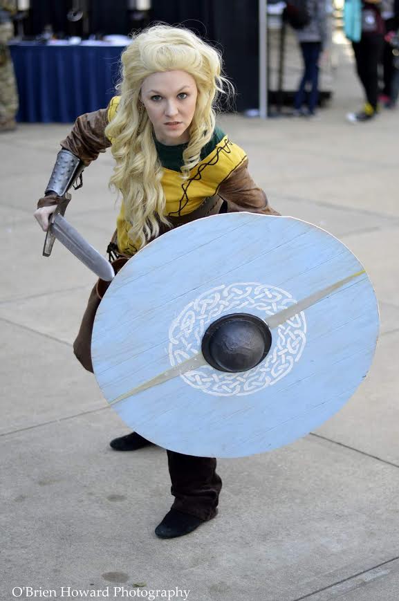 Lagertha Lothbrok- Vikings Tunic made by me(made with faux suede with leather details sewn on. Belt, waist cincher (my first leatherwork), bracers done by me. Husband made the shield I painted it. Sword is a plastic sword leather wrapped and painted by me. My husband looks like Ragnar! This was my first group cosplay (husband was Ragnar and our friend was Rollo) and my first group cosplay 1st place winner. We went big. We won big. Photography by O'Brien Howard of Great Eye Photography: www.greateyeportraits.com