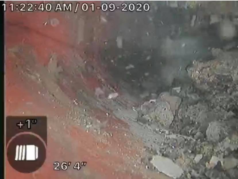 Sewer scope inspection revealing rocks and debris in an older clay pipe, common sewer defect found in Portland, OR and Vancouver, WA homes