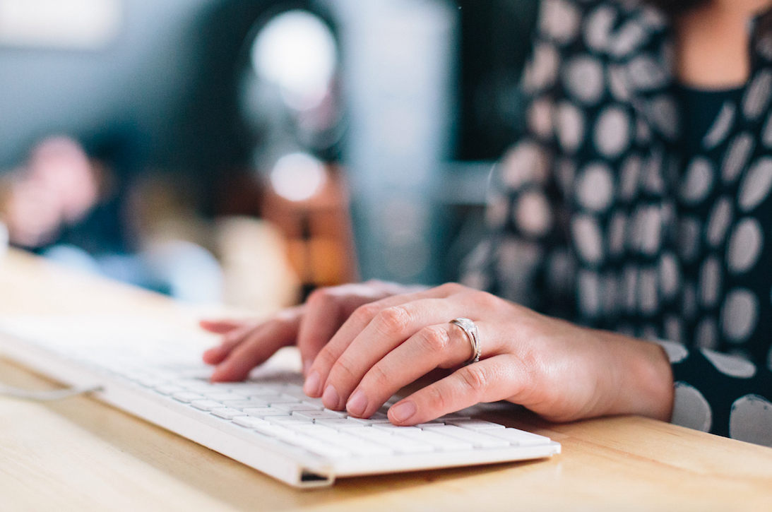 Canberra woman writing website content for a finance company on a computer