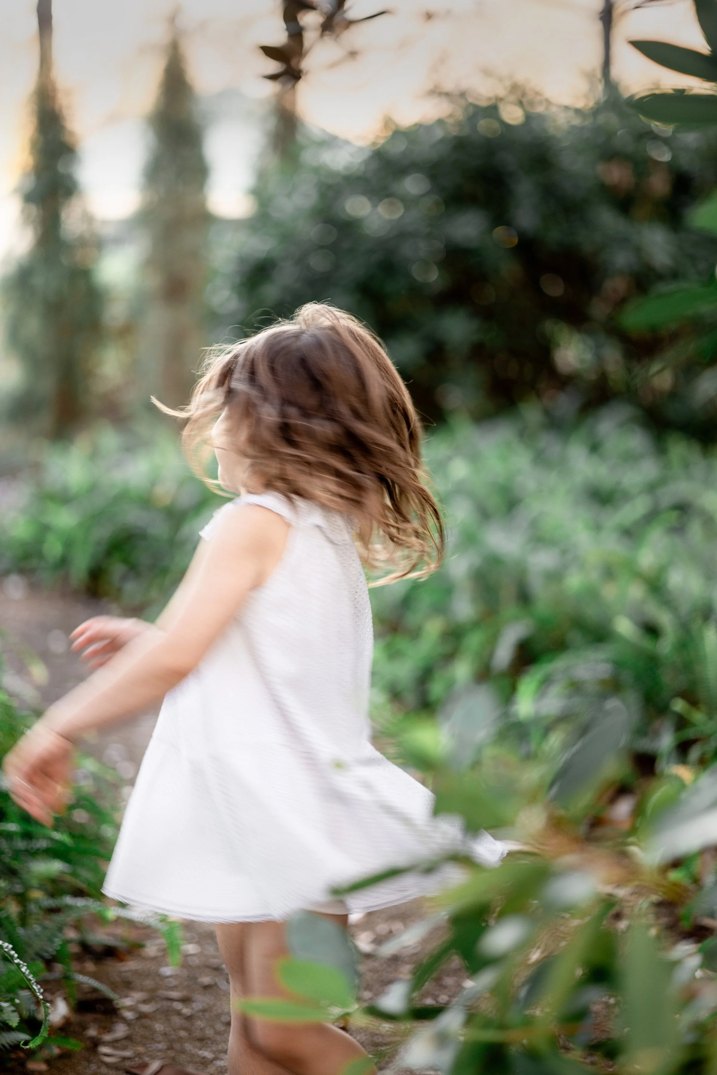 girl spinning at sunset during birthday photo session