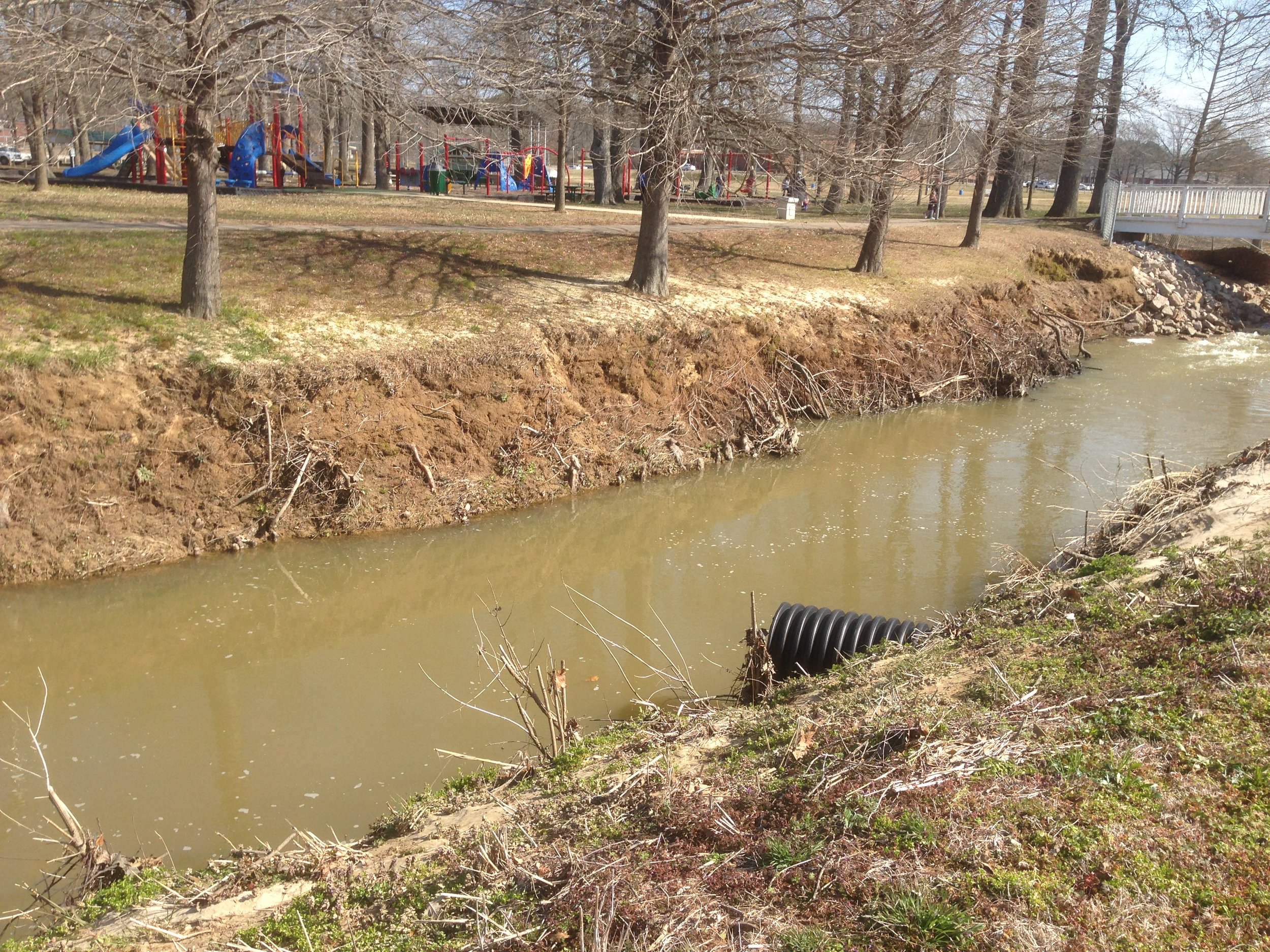 "Before" photo depicting severe erosion along Crooked Creek within Selmer, TN's City Park. April, 2013. Provided full civil site design, permitting through TDEC and the US Army Corps of Engineers, and construction administration. Design Lim
