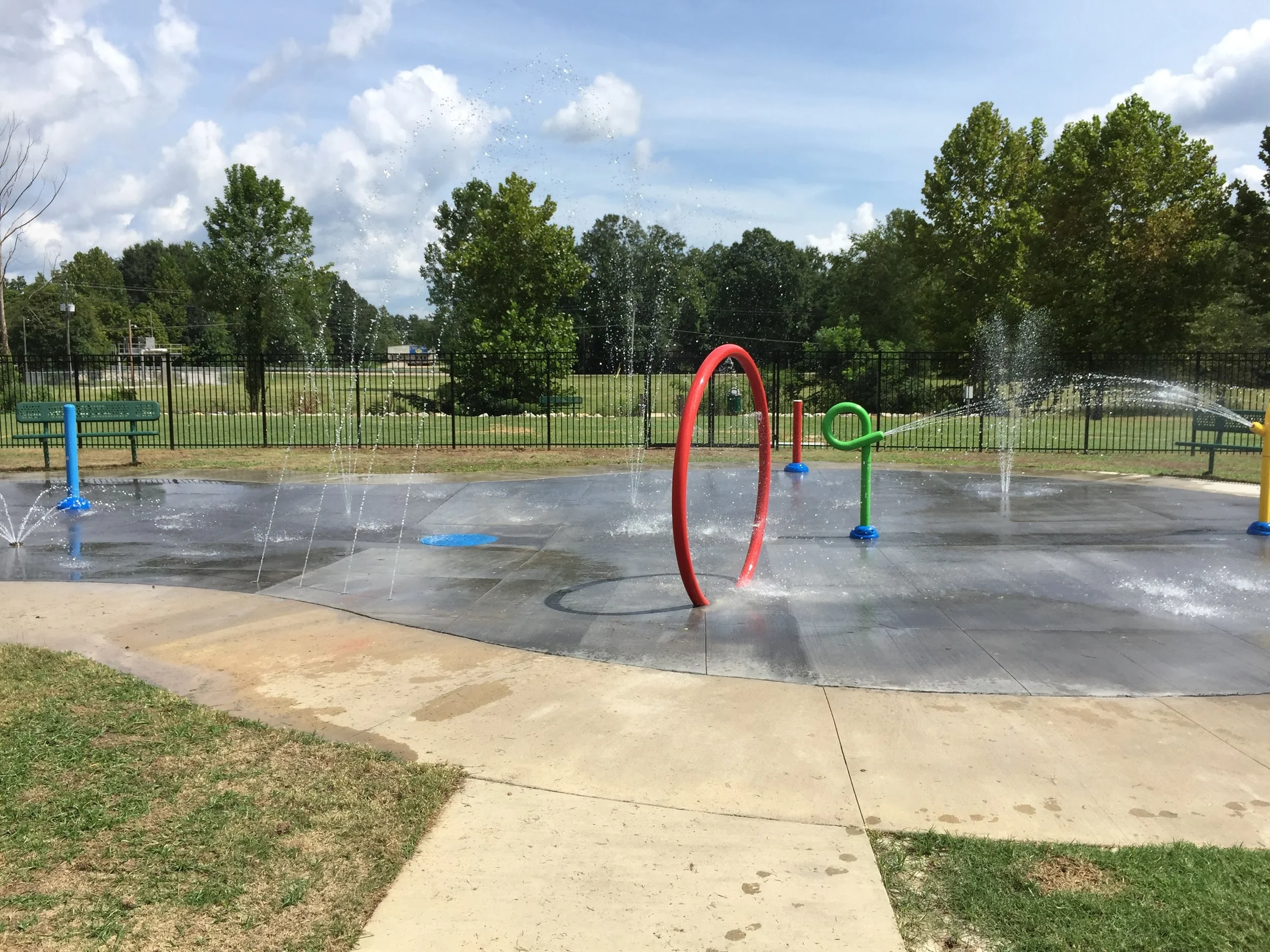 Selmer, TN's Dixie Park Renovations, including a new splash pad, ADA-compliant bathroom, and parking lot. Completed in May, 2016. Provided full civil site design and permitting. Design Limitations: Site located entirely within the floodway of Cypress Creek, which elevated the bathroom structure and caused drainage challenges within the parking lot.