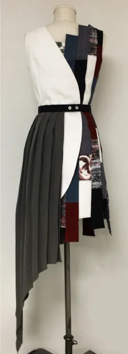 Bre Ferrara, “Mujer Gris.” Work inspired by Juan Gris and the painting, Still Life with a Guitar (1913).  Detachable belt with grey flounce over wrap dress.Student used scraps from previous work, included hand-painted and hand-quilted fabrics to pie…