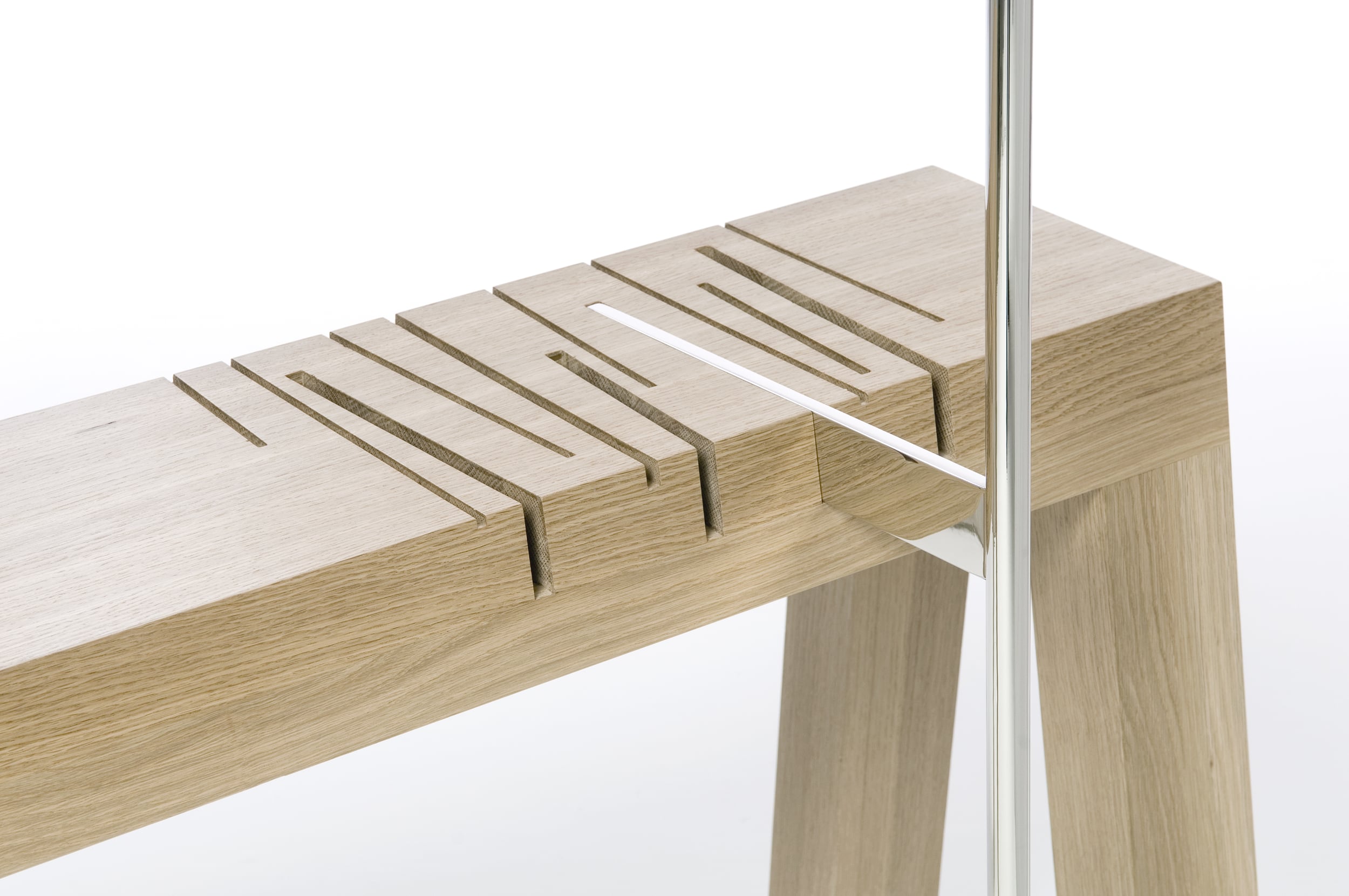 Paying homage to our ancestral furniture makers, Saw is at once sculpture and functional furniture. The solid wood table contains several stylized “saw cuts” into which the nickel-plated lamp post is inserted, each providing a different intensity of