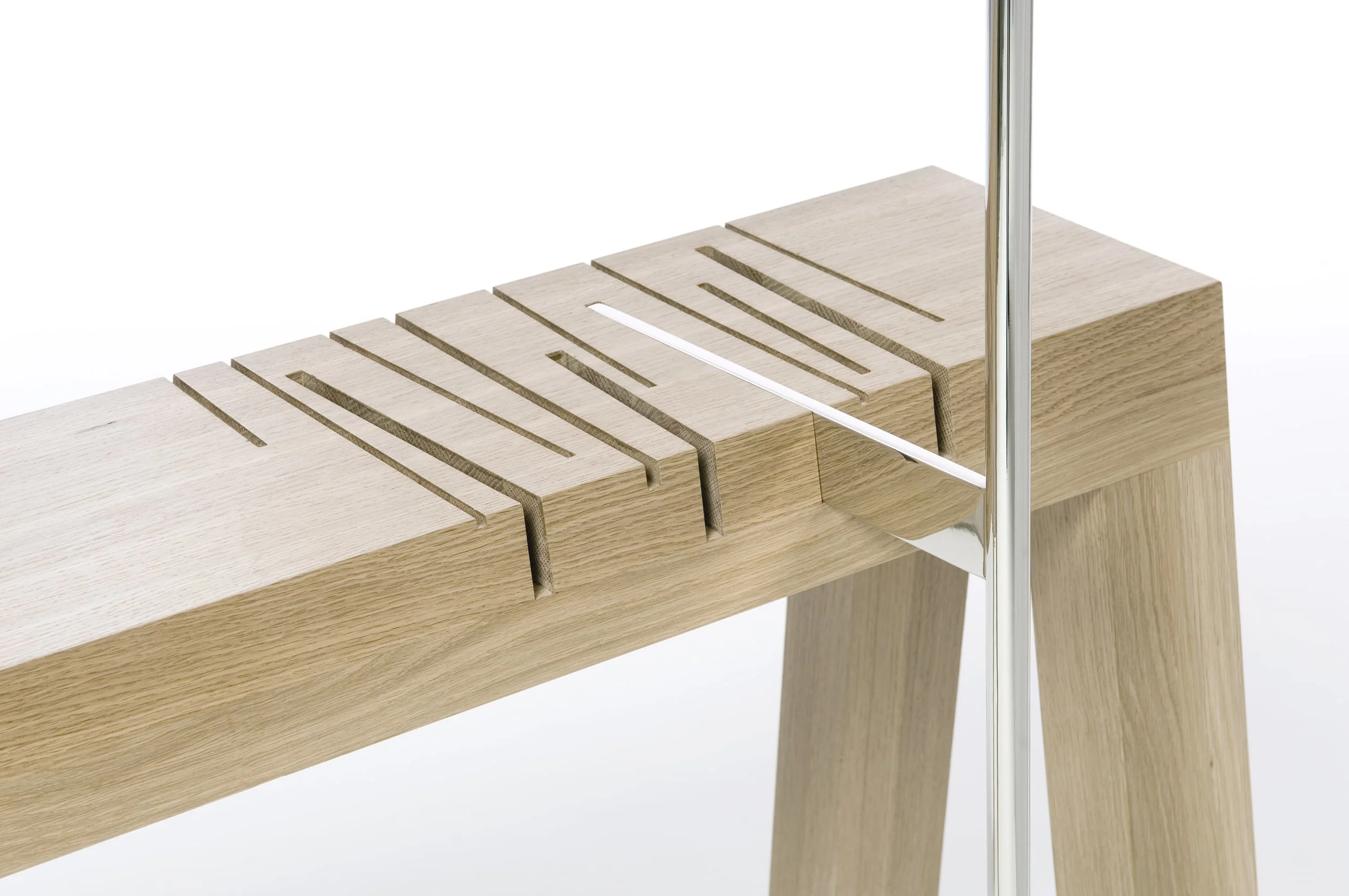 Paying homage to our ancestral furniture makers, Saw is at once sculpture and functional furniture. The solid wood table contains several stylized “saw cuts” into which the nickel-plated lamp post is inserted, each providing a different intensity of light or no light at all when placed in the resting slot. In this age of convenience and technology, Saw hearkens back to a time when the lighting and dousing of a lamp was a more purposeful act, a domestic ritual punctuating the beginning or the end of an evening.