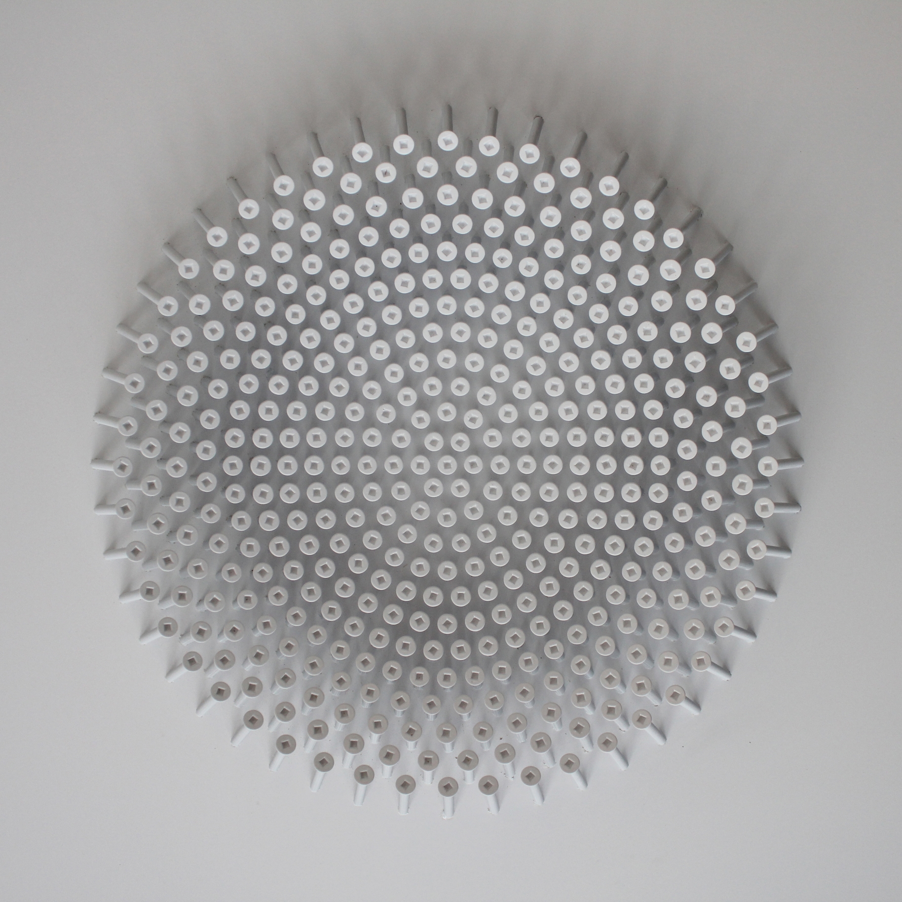 Robertson machine screws are meticulously arranged into three effective bowl shapes, each being permanently fixed to their base counterparts. It is here where the screw, perhaps the definitive object of utility, is transformed into something elegant