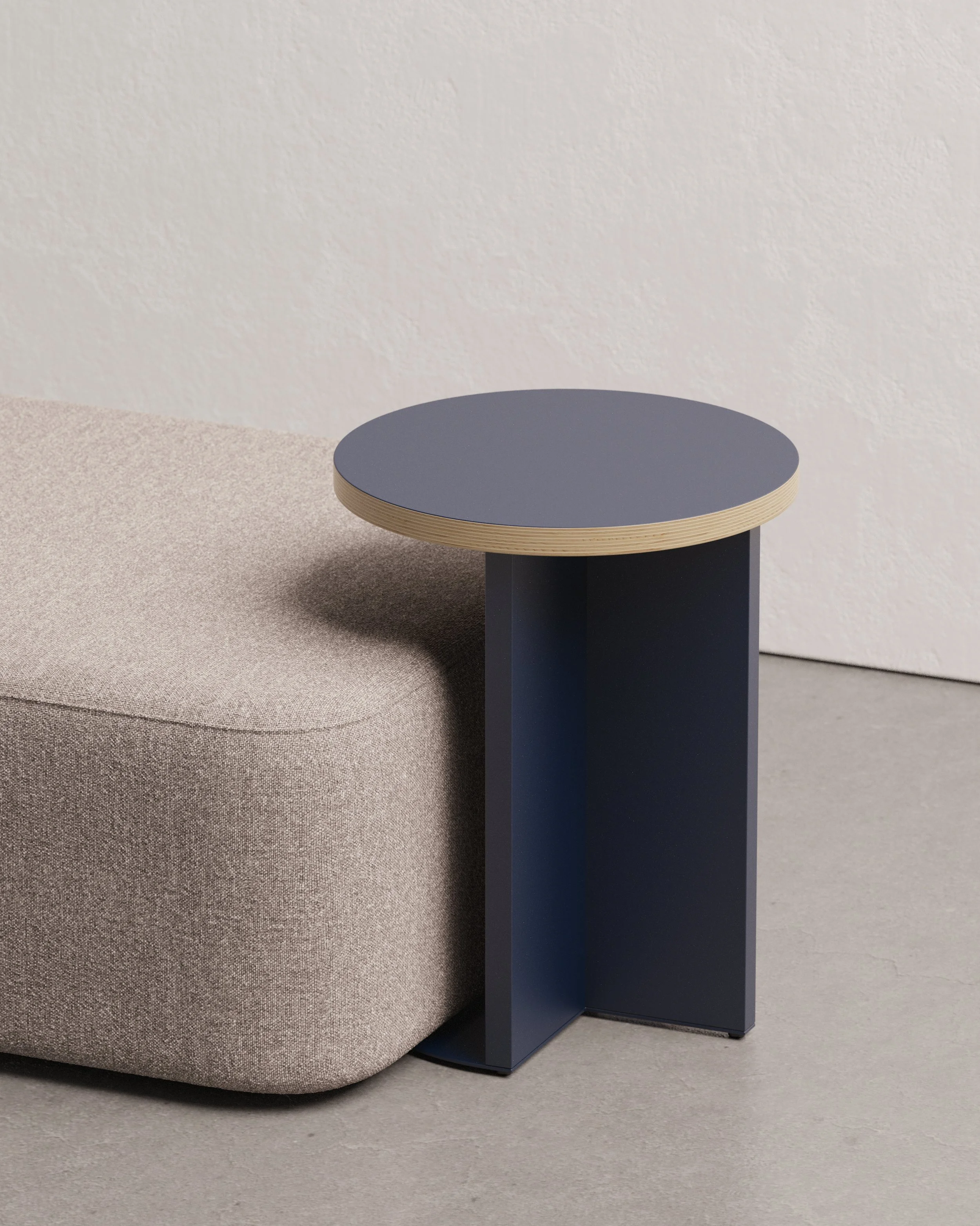 A simple and versatile pull-up table designed to both functionally and visually enhance workspaces. Its clean, intersecting planes give it a distinctive character, and it is available in two heights. 24 inches for laptop use and 20 inches as a side