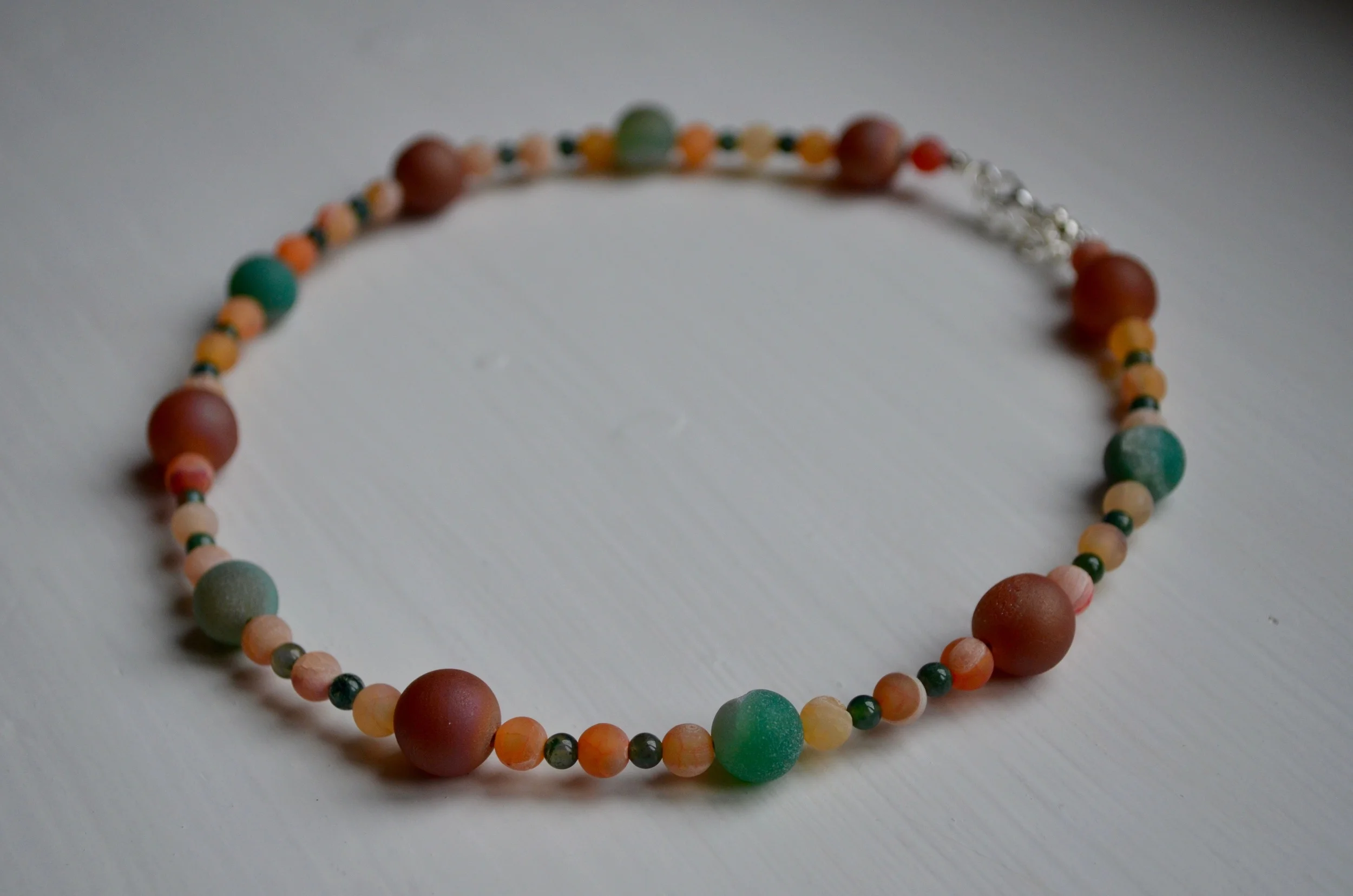 Green, copper and orange hued agates with drusies