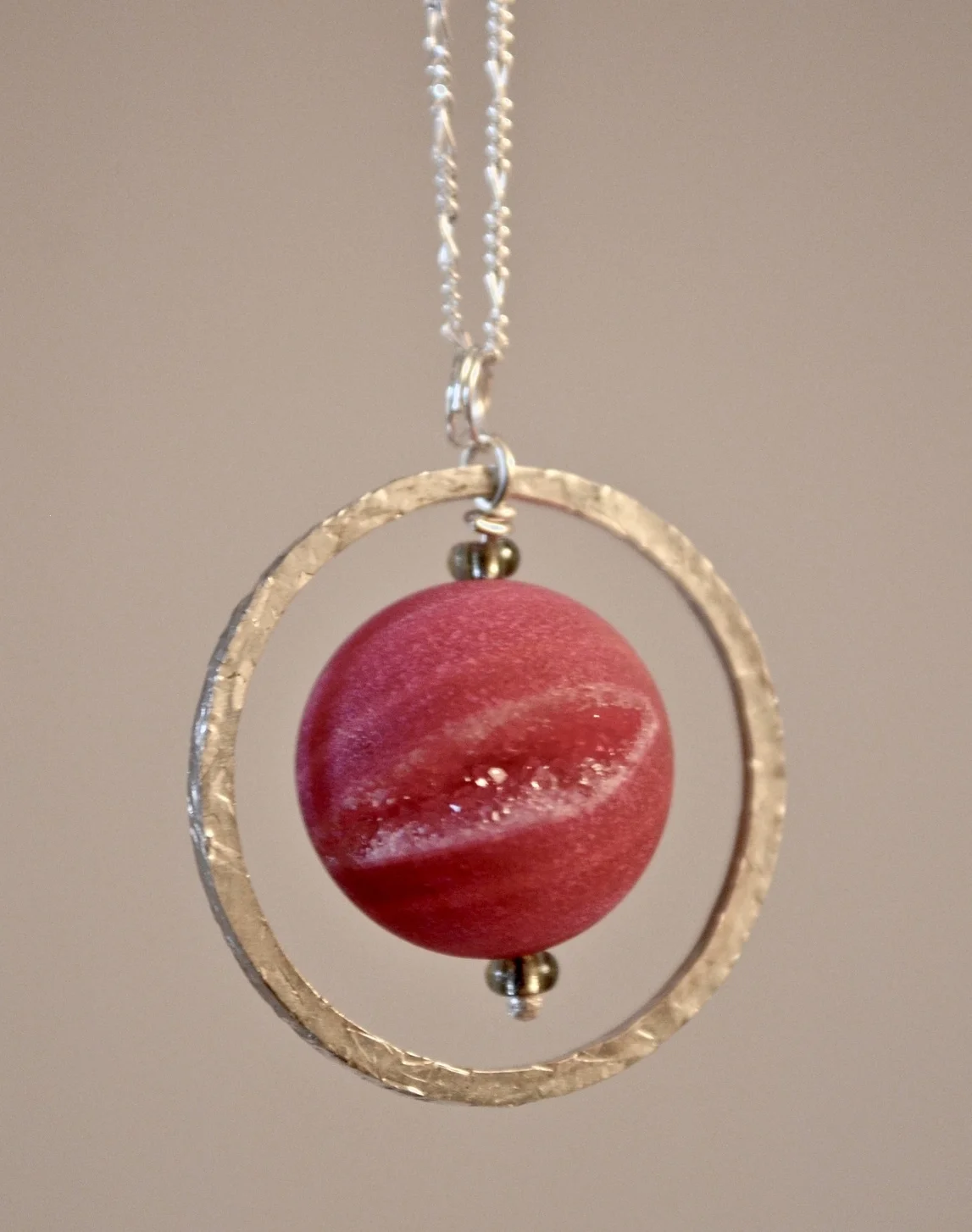 Frosted agate with drusy spinning within a textured ring. Also in frosted green agate. Sterling silver chain included. 