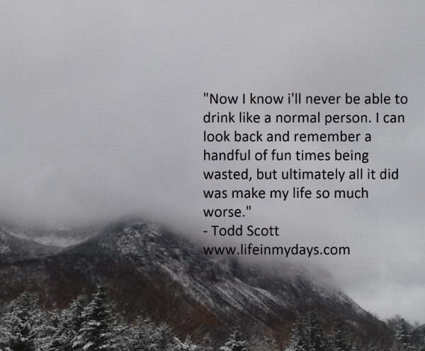 Photo Description: Misty clouds roll over a snowy mountain top. White snow collects on dark trees.