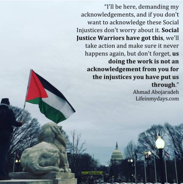 Photo Description: A man carries a palestinian flag by a statue for a lion in Union Square overlooking Capital Hill. 