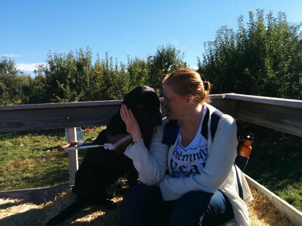 Photo Description: Sarah stares into Ferdie's eyes as they enjoy a hayride in an apple form, with beautiful blue sky in the background. 