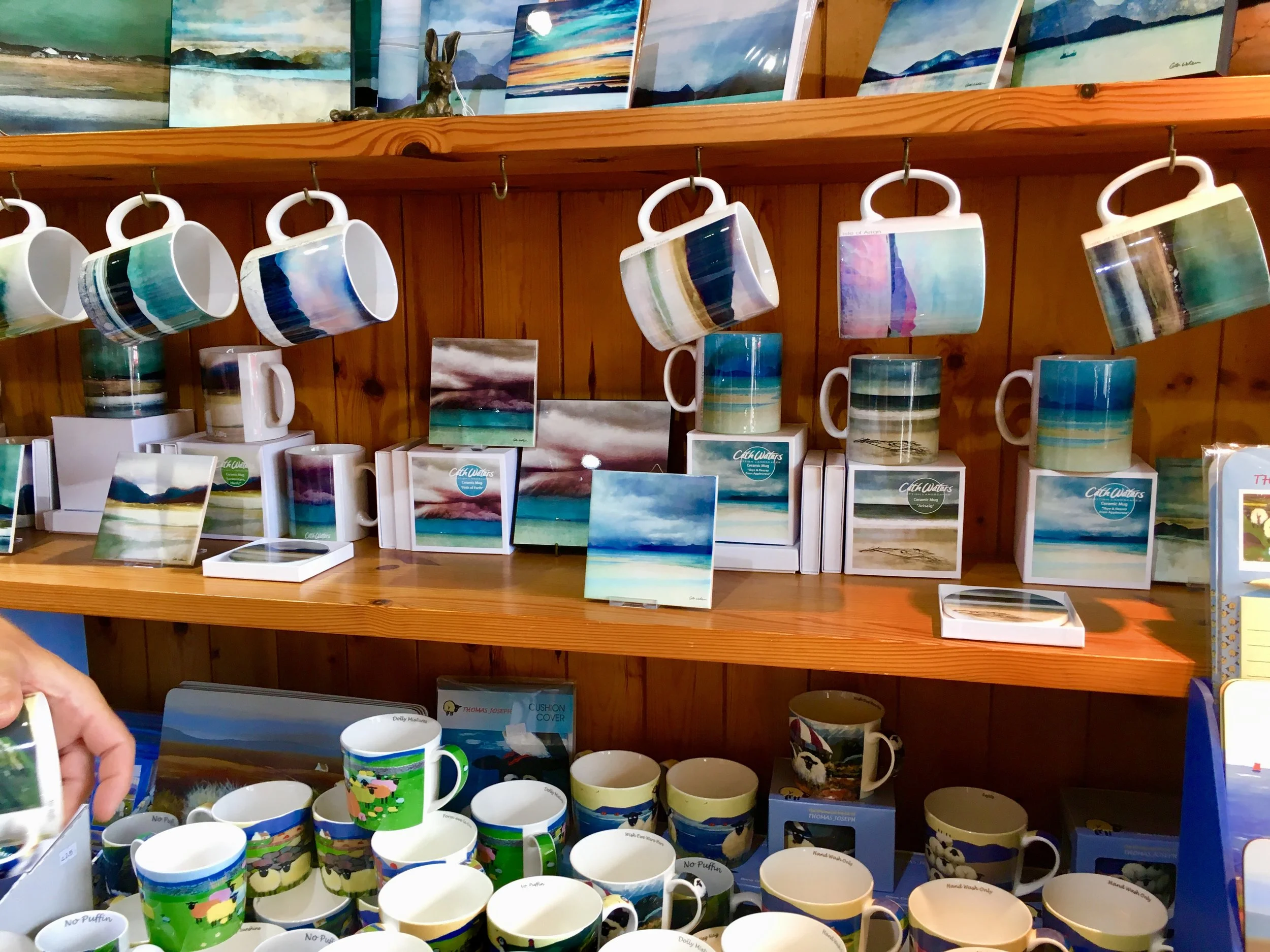 The selection of mugs with abstract vistas is a popular sell at Mull Pottery.