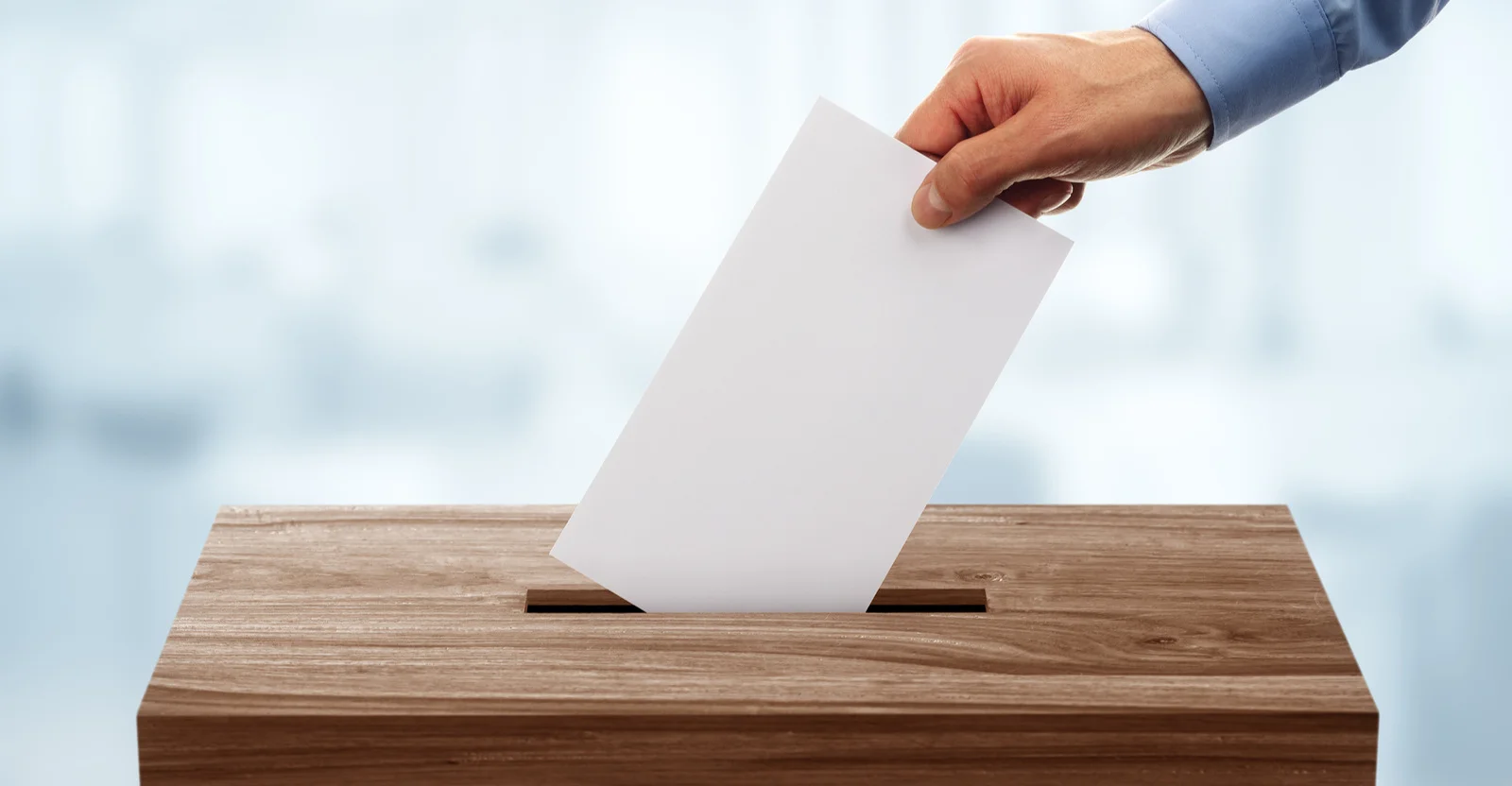 bigstock-Ballot-box-with-person-casting-107447402.jpg