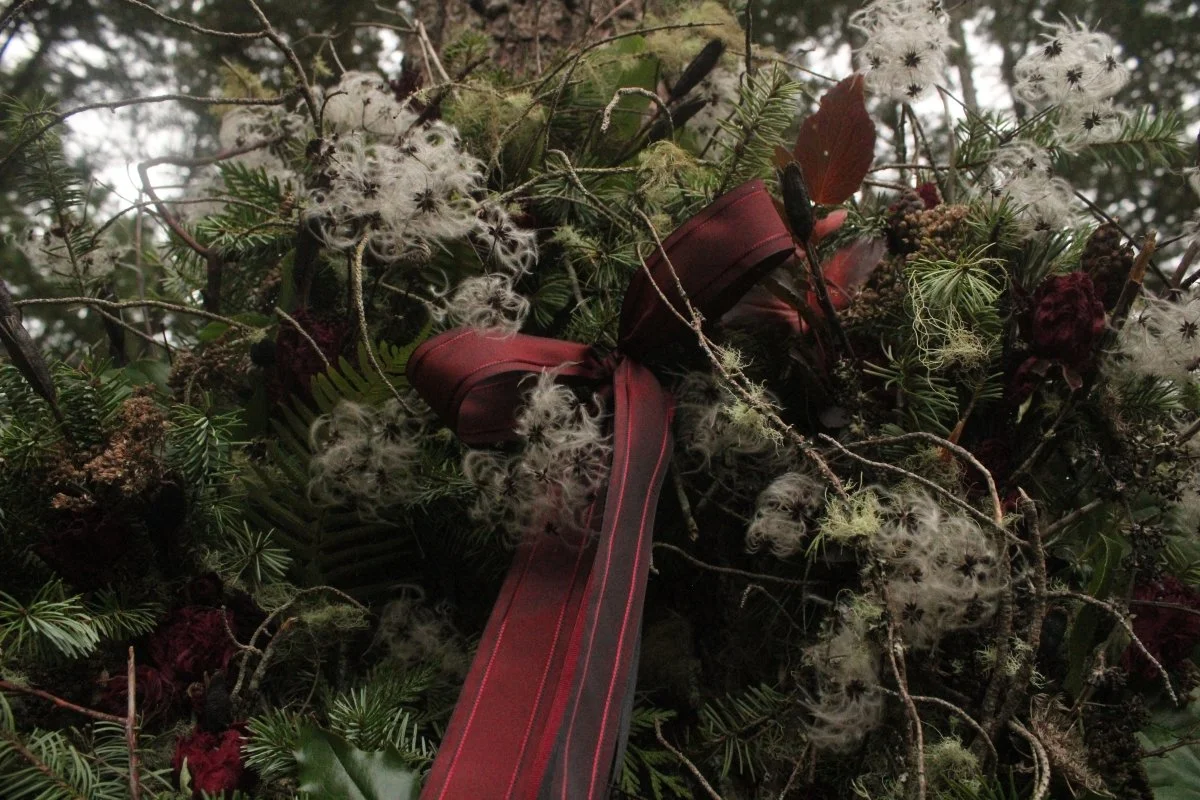 A romantic, moody berry and scarlet woodland Christmas wreath designed by Cat Brimhall of Westerwisp