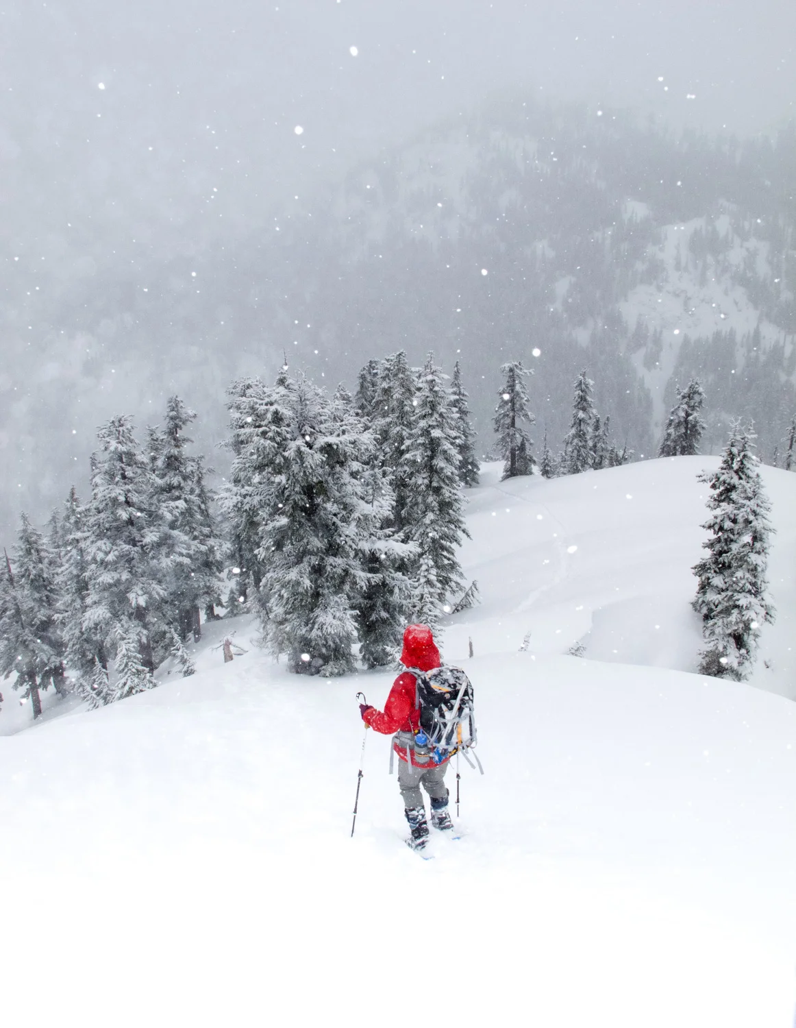Mountaineer descending during a light snowfall