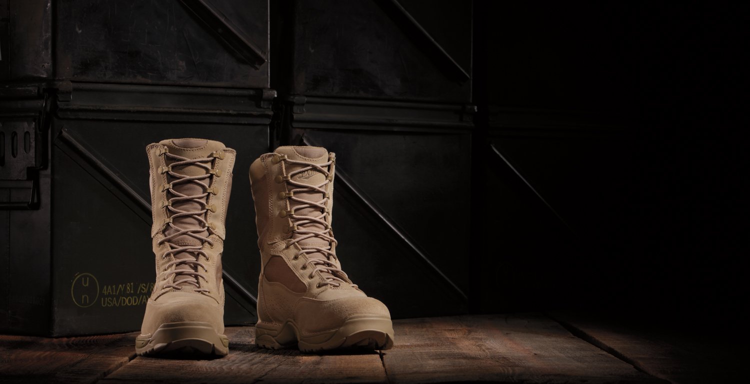  Product photography shot in studio: pair of sand colored boots. 