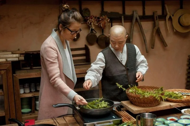 CHEF SARA HENKE WITH BUDDHIST MONK JEONGE KWAN IN SOUTH KOREA COOKING