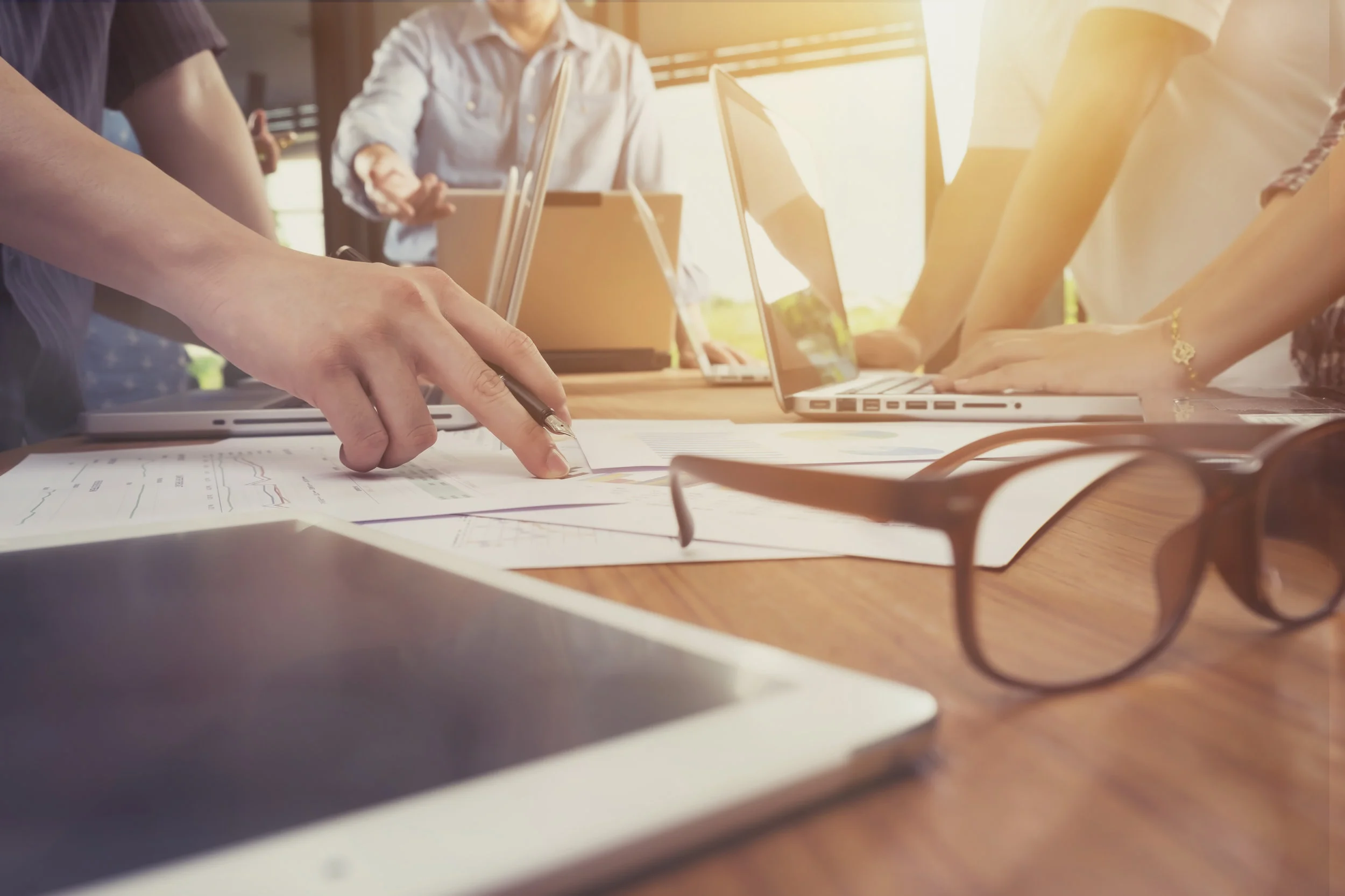 stock-photo-business-man-hand-pointing-at-business-document-during-discussion-at-meeting-vintage-tone-428690086.jpg