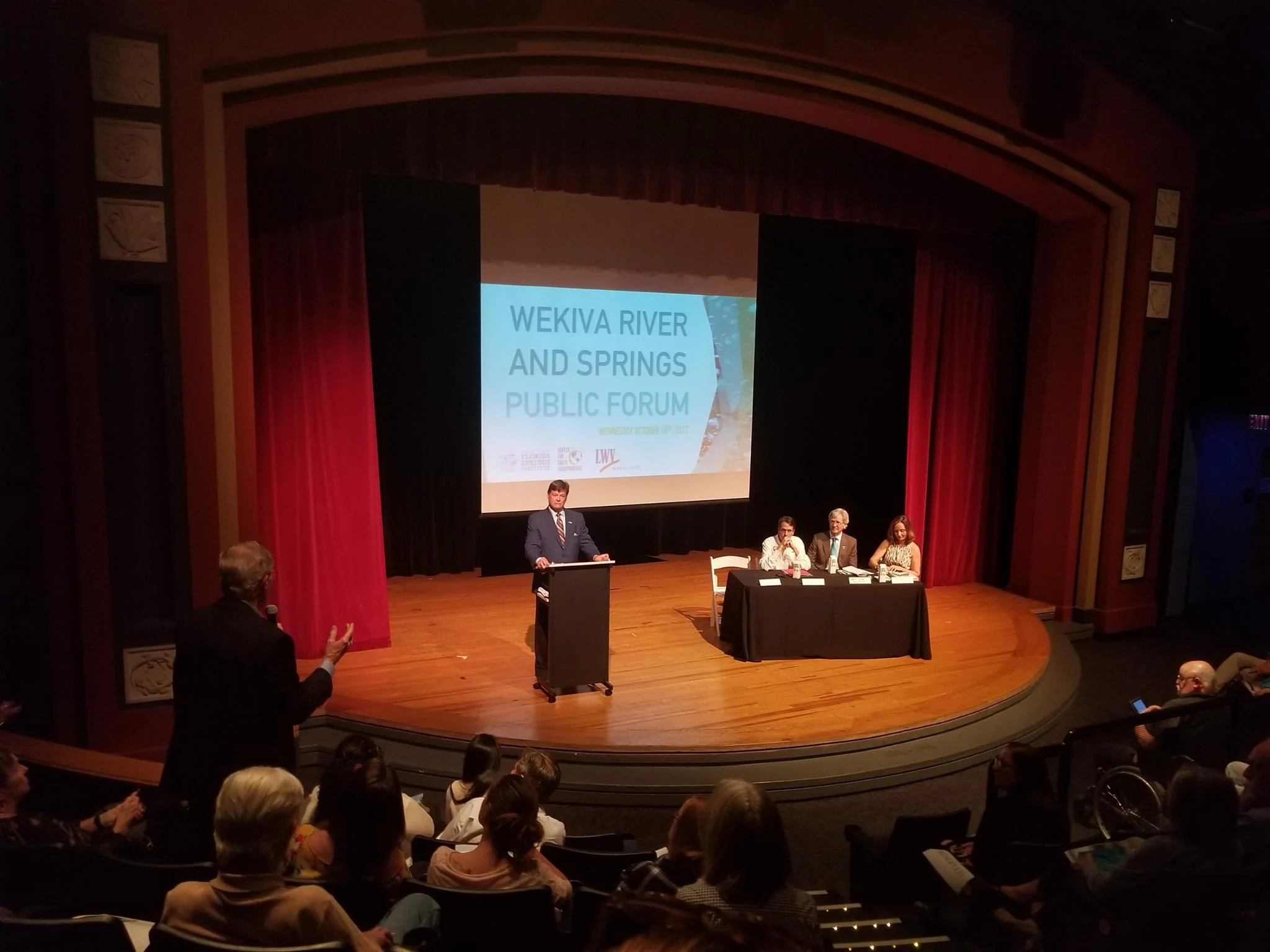 Attendee asking a question of our esteemed panel. Moderator Lee Constantine, Panelists Drew Bartlett, Marty Sullivan, and Aliki Moncrief. Photo courtesy of Katrina Garvin Shadix.
