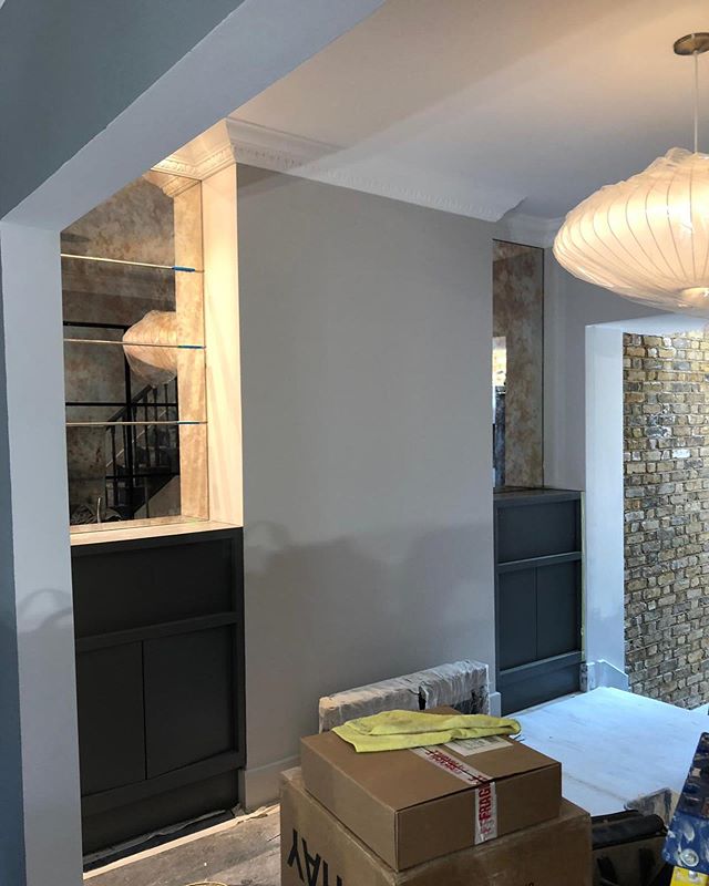 Pre moving in shot of a clients amazing home. These are the existing units, painted in a new colour, with antique mirror added above and 2 @hermanmiller bubble saucer lights. You can see the reflection of the crittall wall in the dining room. This on