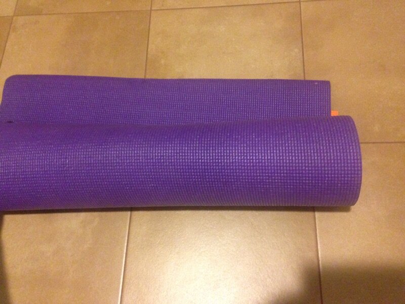 Roll the yoga fitness mat after folding in half