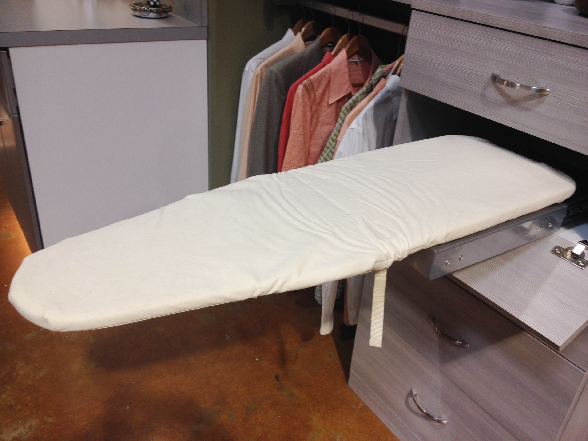Stowaway pull-down ironing board