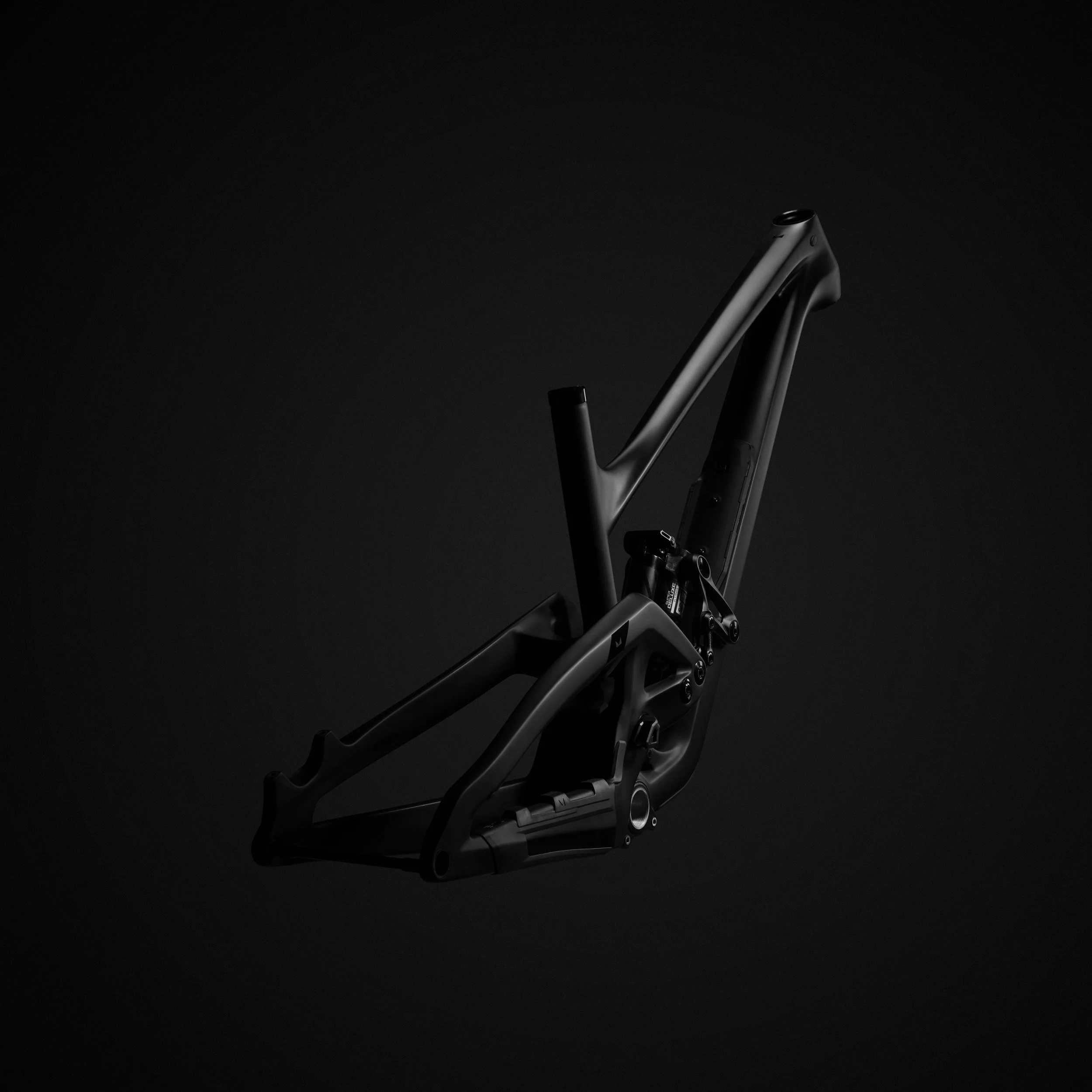 A black bicycle frame against a dark background.