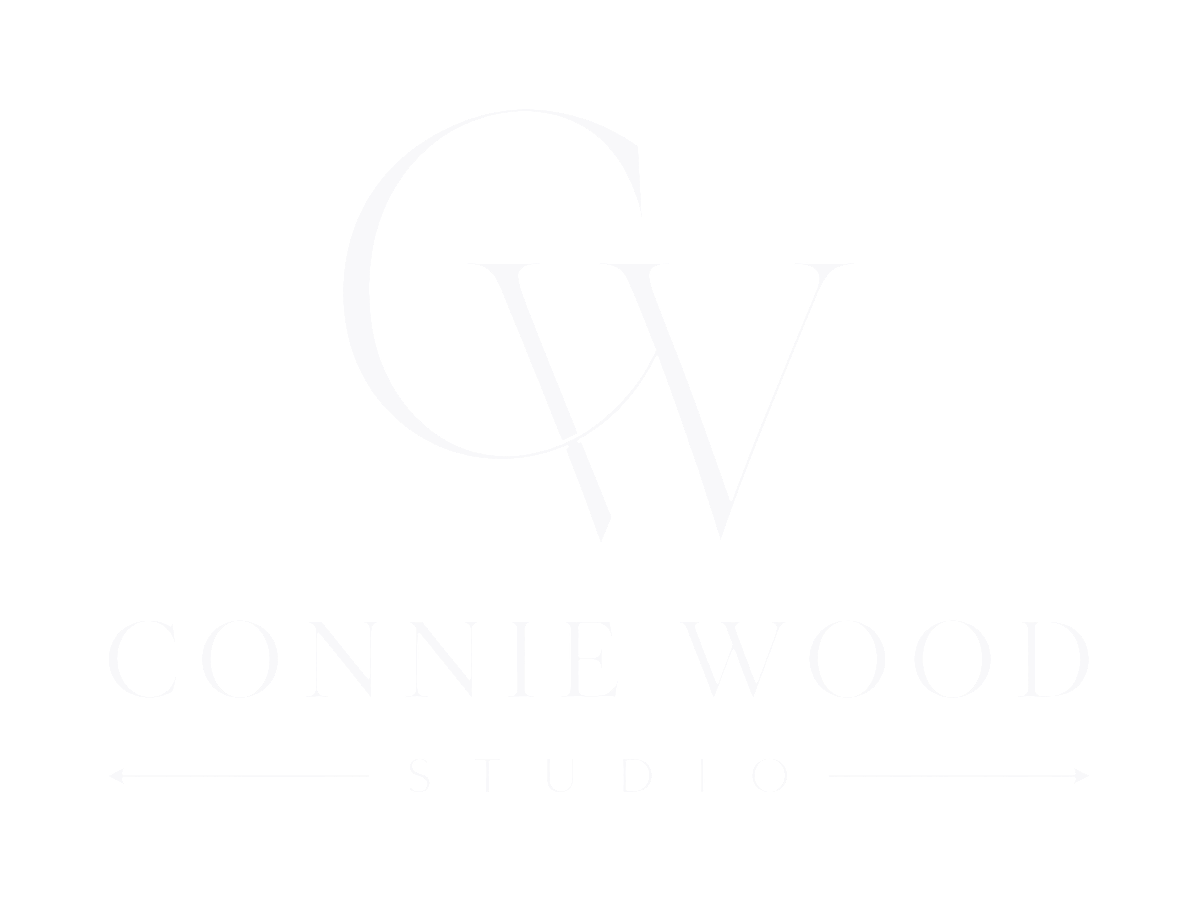 Black background with white logo displaying initials 'C W' and text 'Connie Wood Studio' underneath, with arrows pointing left and right.