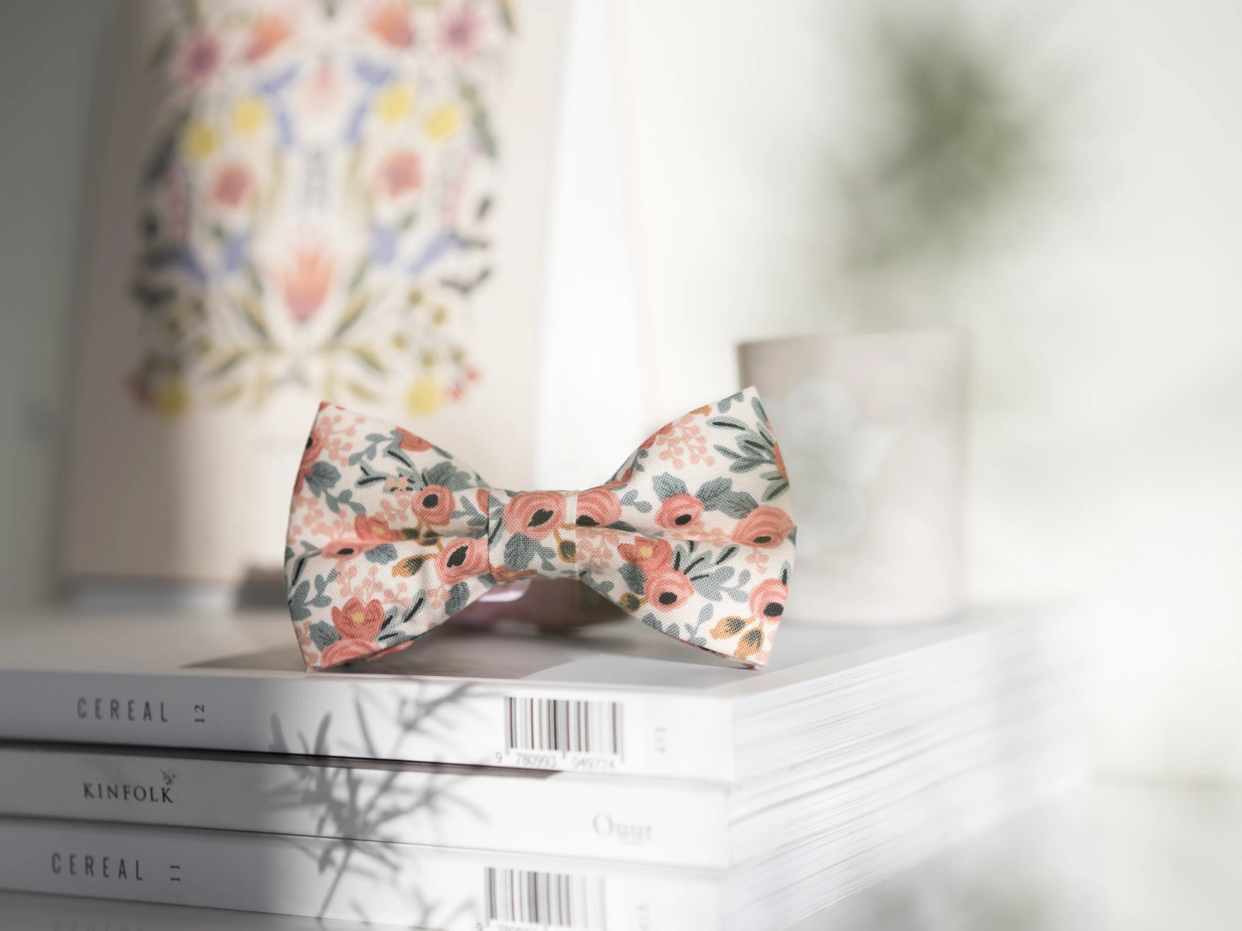 pink rifle paper co floral fabric bow tie on top of cereal magazine