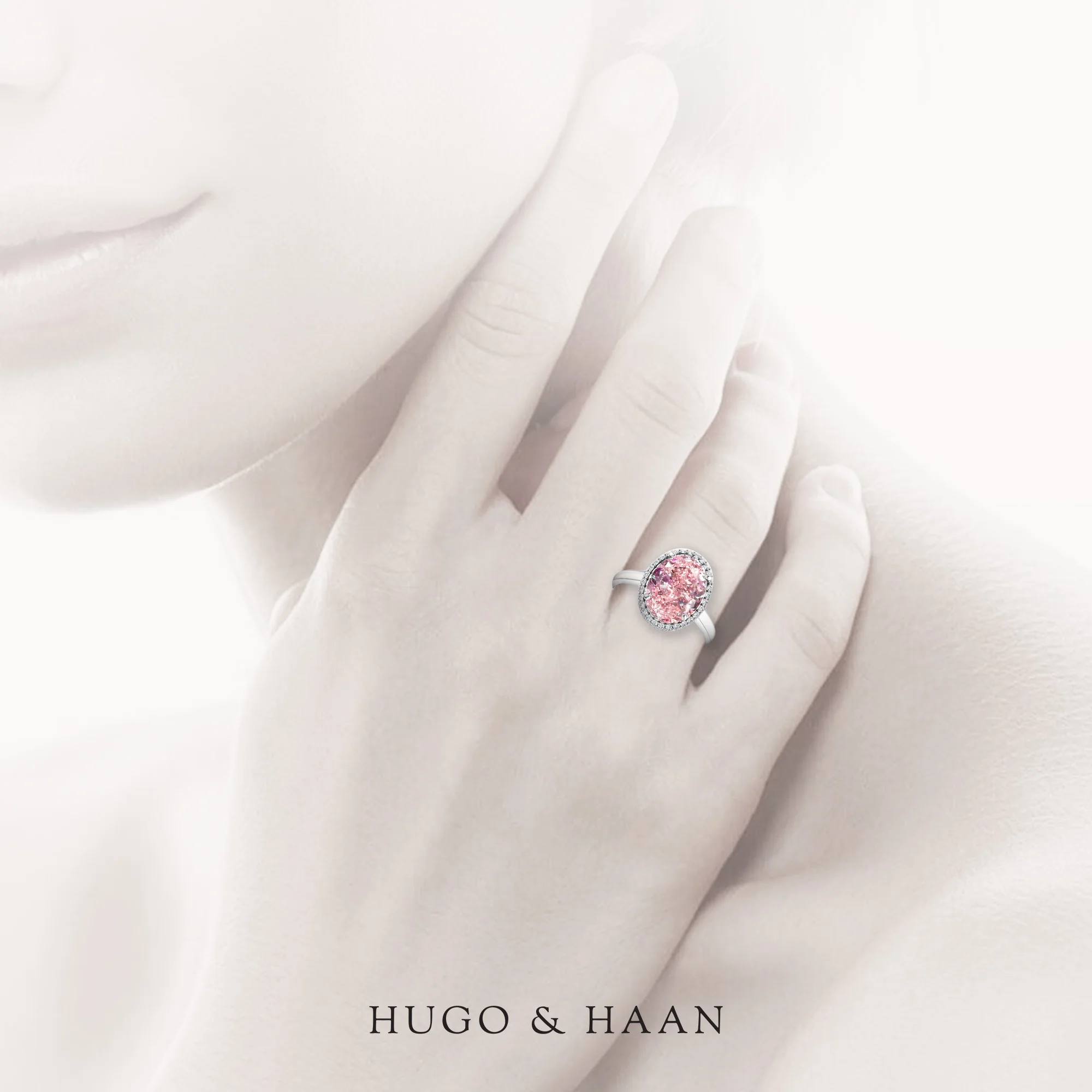 oval-cut-pink-sapphire-engagement-ring-in-platinum-on-hand.jpg