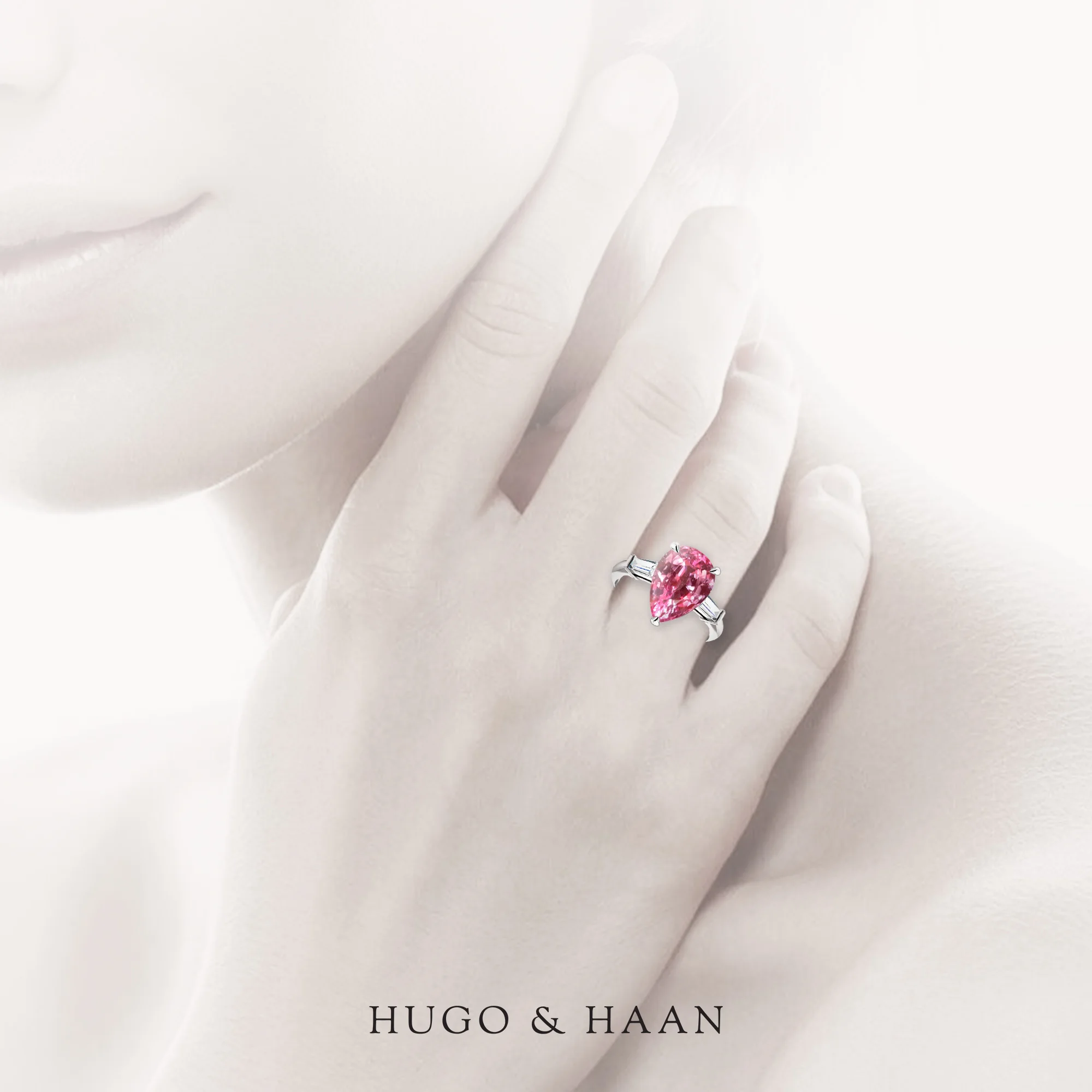 hugo-haan-platinum-gold-gia-certified-pear-pink-tourmaline-tapered-baguette-side-stone-trilogy-engagement-ring-on-hand.jpg