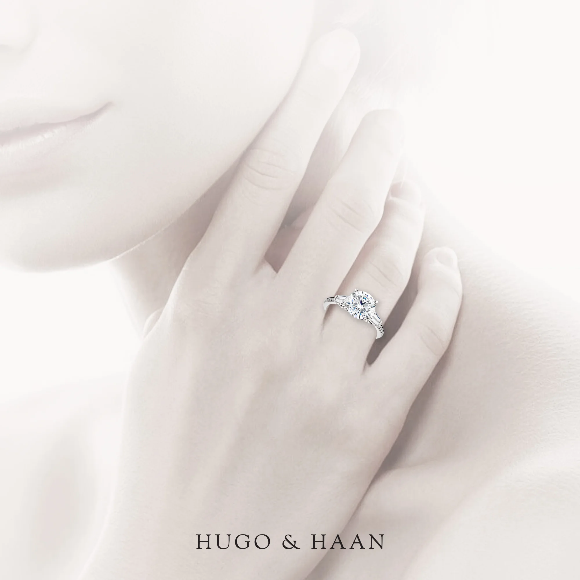hugo-haan-platinum-gold-gia-certified-round-brilliant-diamond-tapered-baguette-side-stone-channel-set-shank-engagement-ring-on-hand.jpg