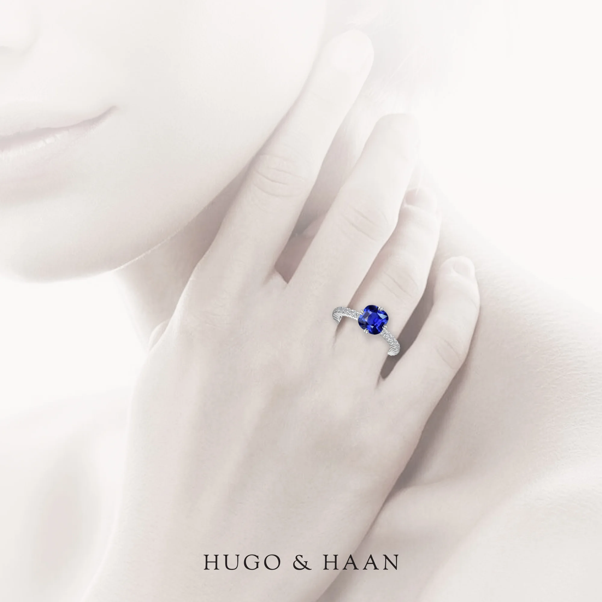 hugo-haan-white-gold-blue-sapphire-accented-shank-engagement-ring-on-hand.jpg