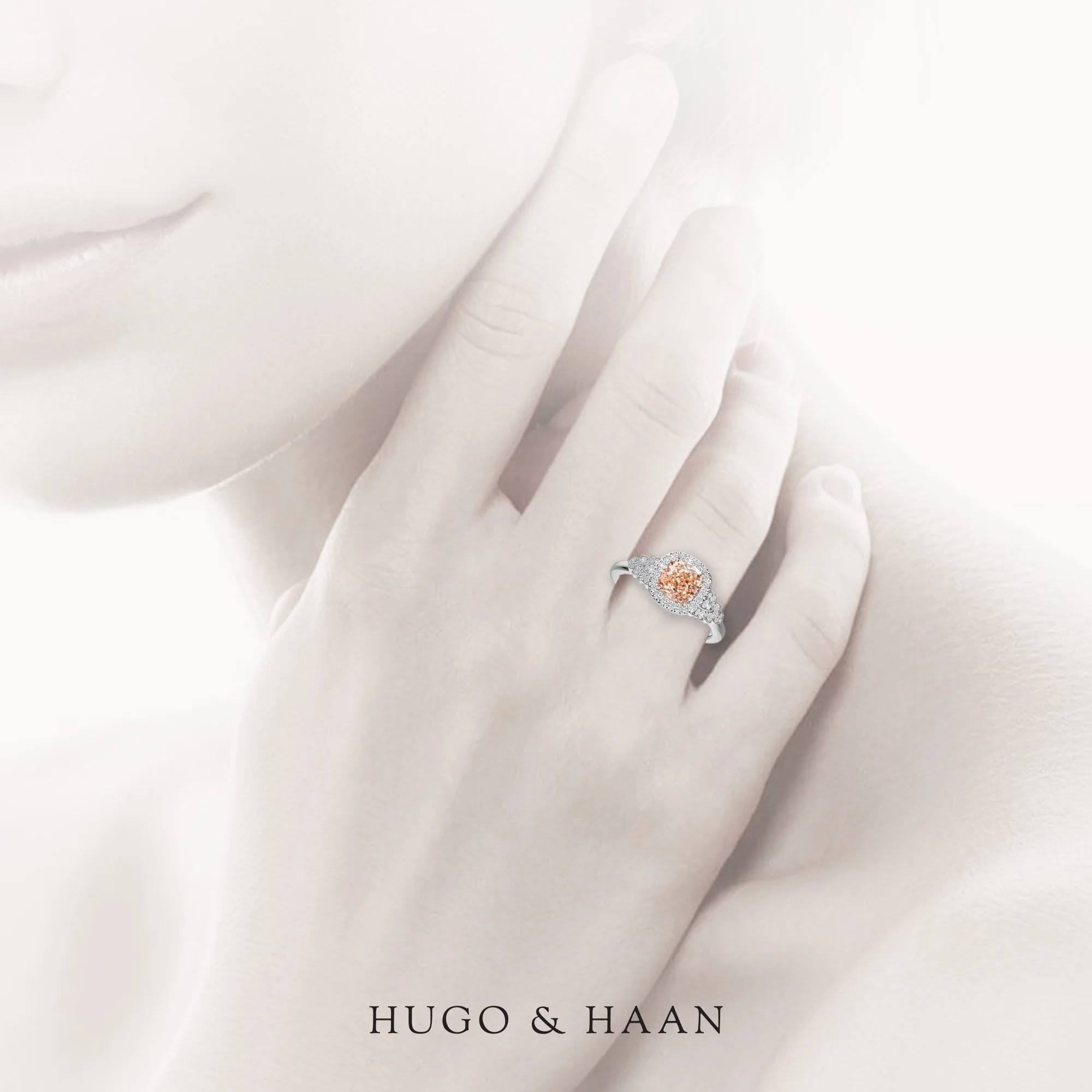 hugo-haan-white-gold-double-halo-cushion-pink-sapphire-trilogy-engagement-ring-on-hand.jpg