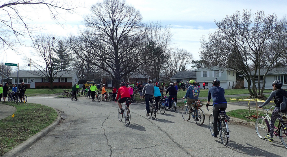 Riders arrive at a house on a quiet street in North Columbus. Photo credit: Ray George